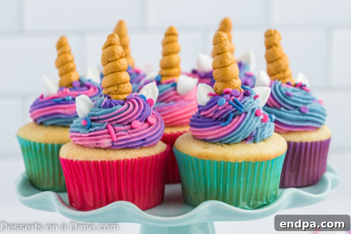 Unicorn cupcakes on a platter, showcasing their pastel frosting and sprinkles.