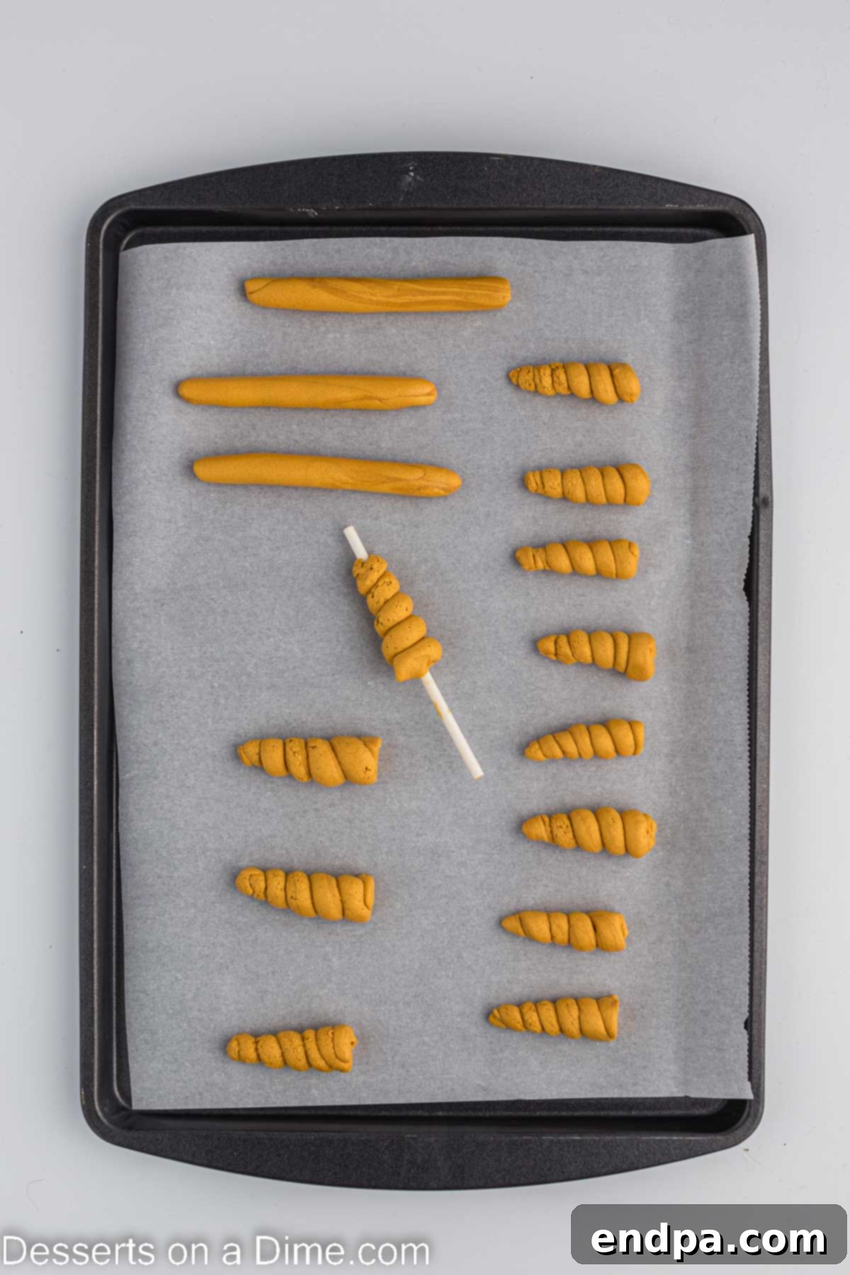 Unicorn horns drying on a baking sheet.