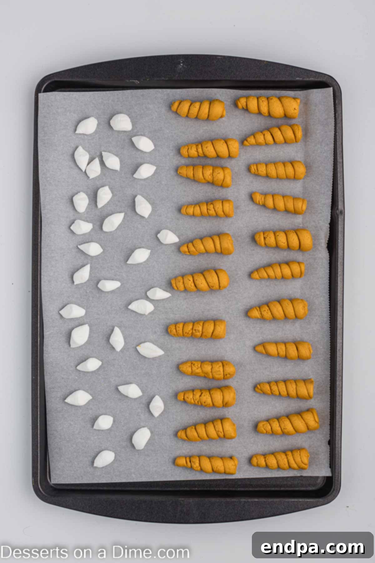 Marshmallow ears arranged on a baking sheet.