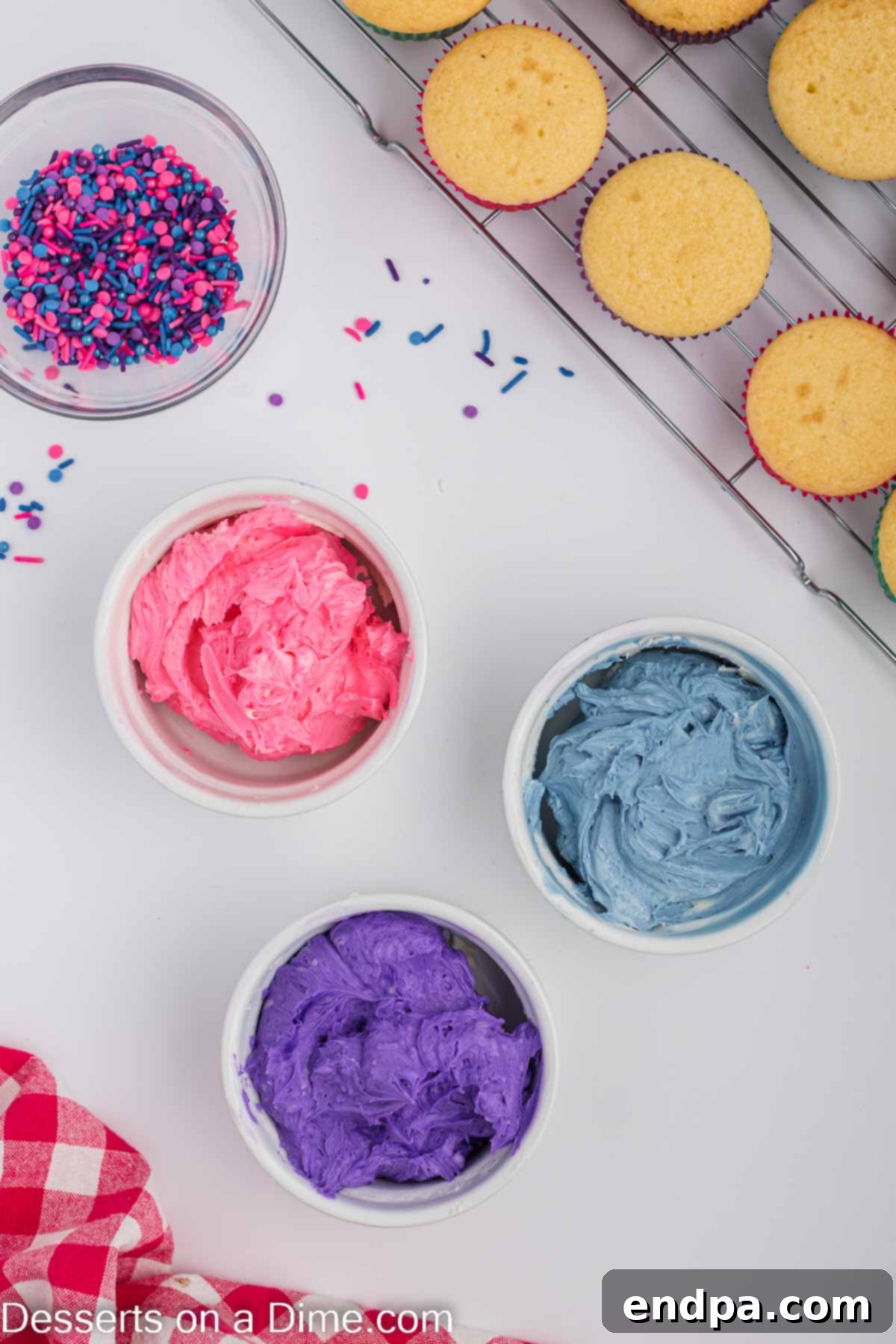 Frosting divided into three bowls for coloring.