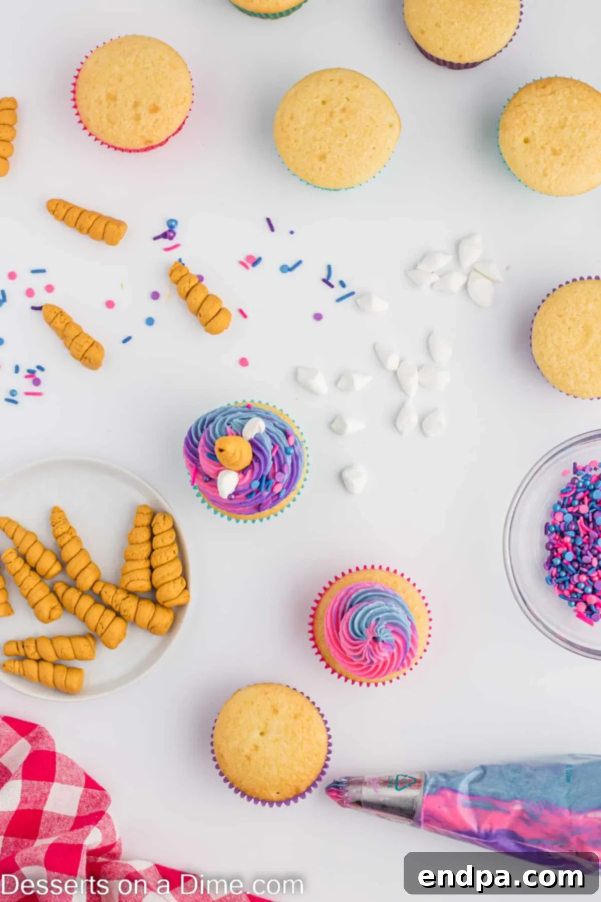 Finished unicorn cupcakes with piped frosting and decorations.
