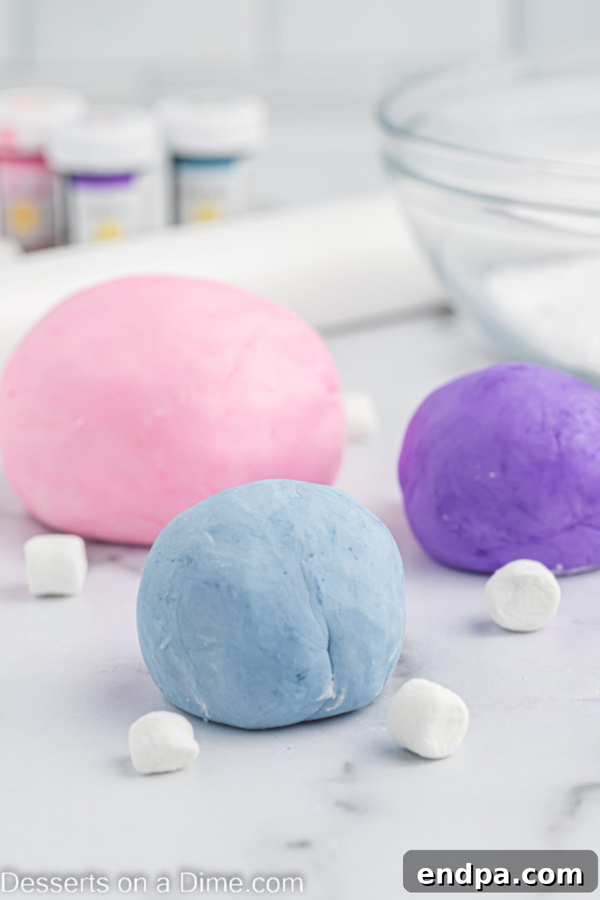Foolproof Marshmallow Fondant 10 Pink, blue, and purple marshmallow fondant balls, showcasing vibrant colors ready for decorating.