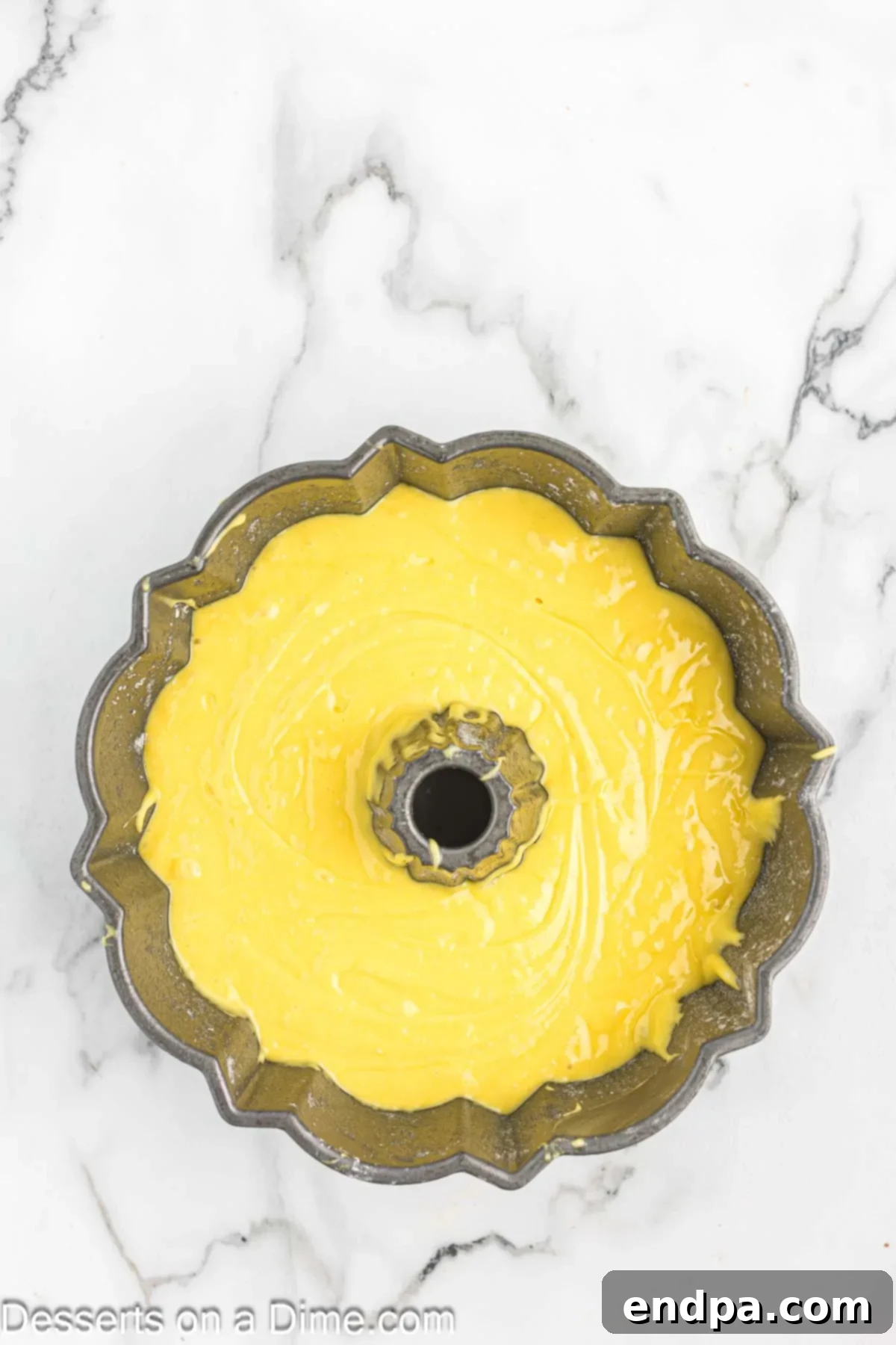 Classic 7 Up Pound Cake 5 Smooth yellow cake batter poured into a prepared bundt pan, ready for baking.