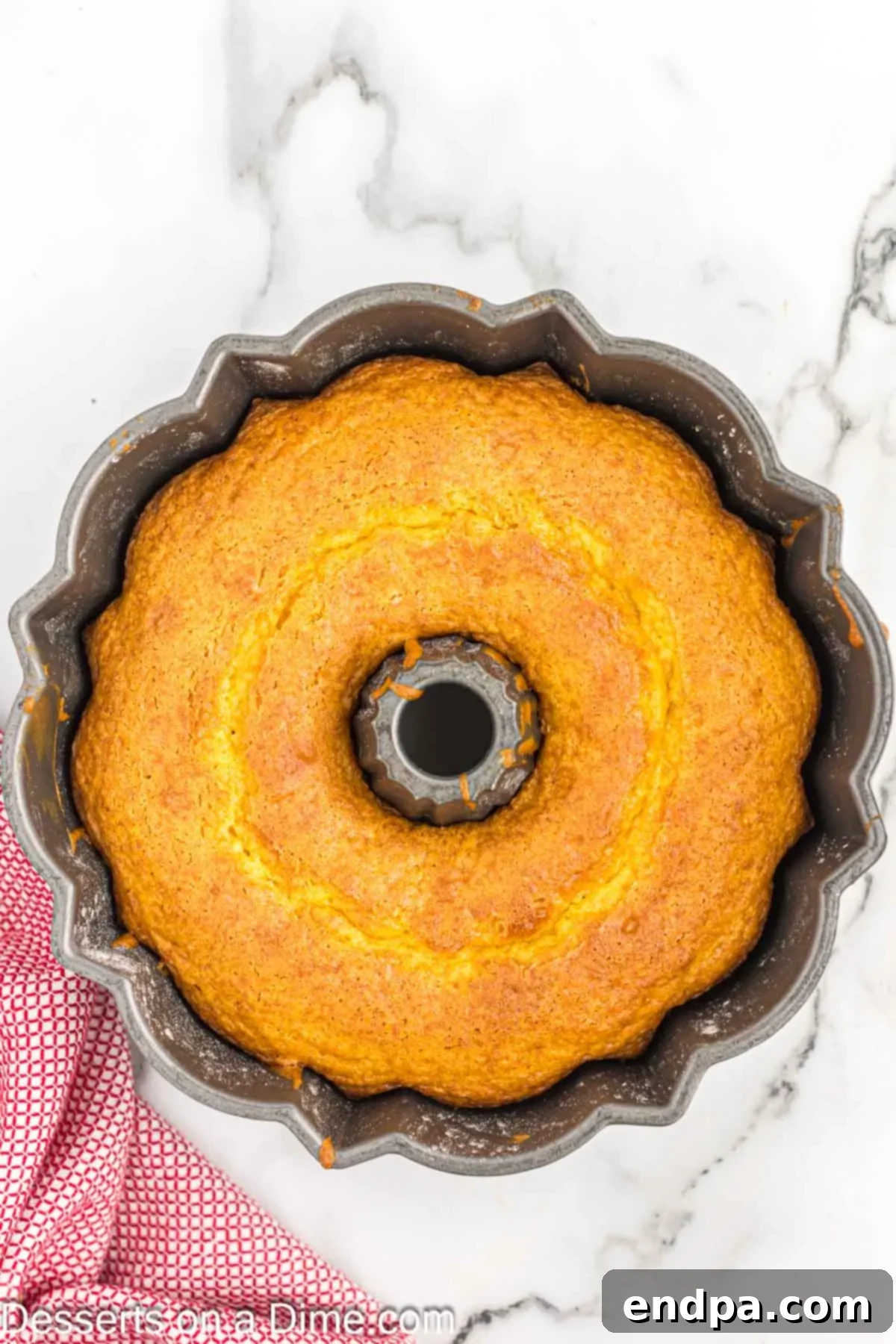Classic 7 Up Pound Cake 6 A perfectly golden-brown 7 Up cake cooling in its bundt pan after baking, steam gently rising.