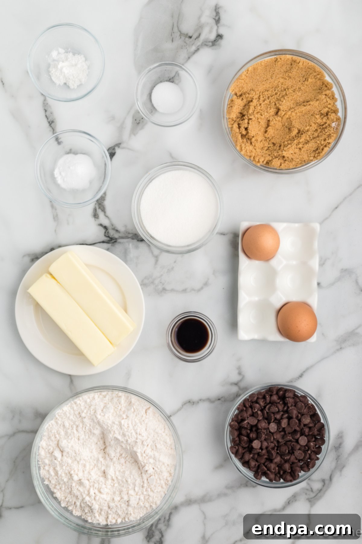 Ingredients for Mrs. Fields chocolate chip cookies: softened unsalted butter, granulated sugar, packed brown sugar, large eggs, pure vanilla extract, all-purpose flour, salt, baking soda, baking powder, and semi-sweet chocolate chips.