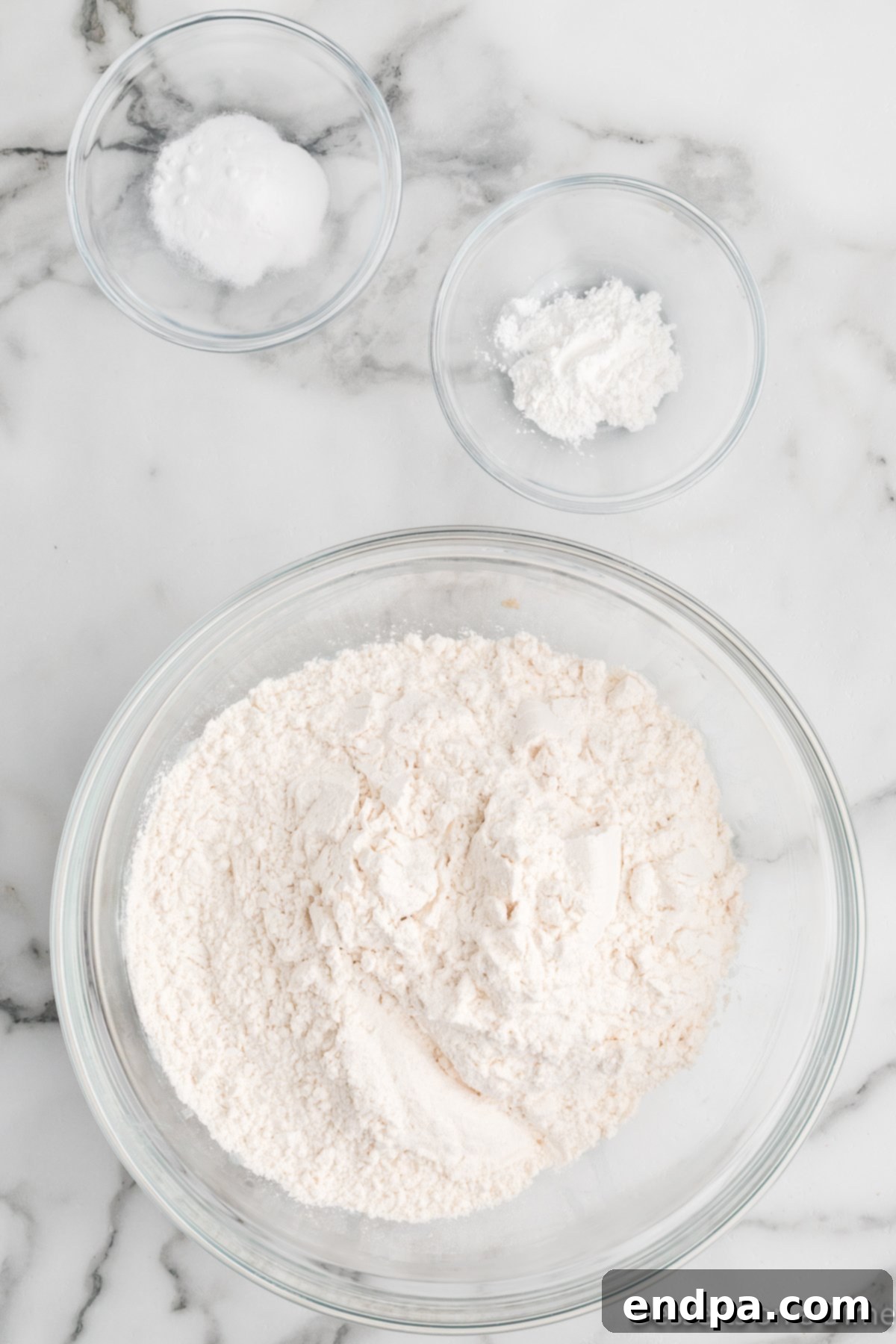 Dry ingredients including flour, salt, baking soda, and baking powder combined in a separate bowl.