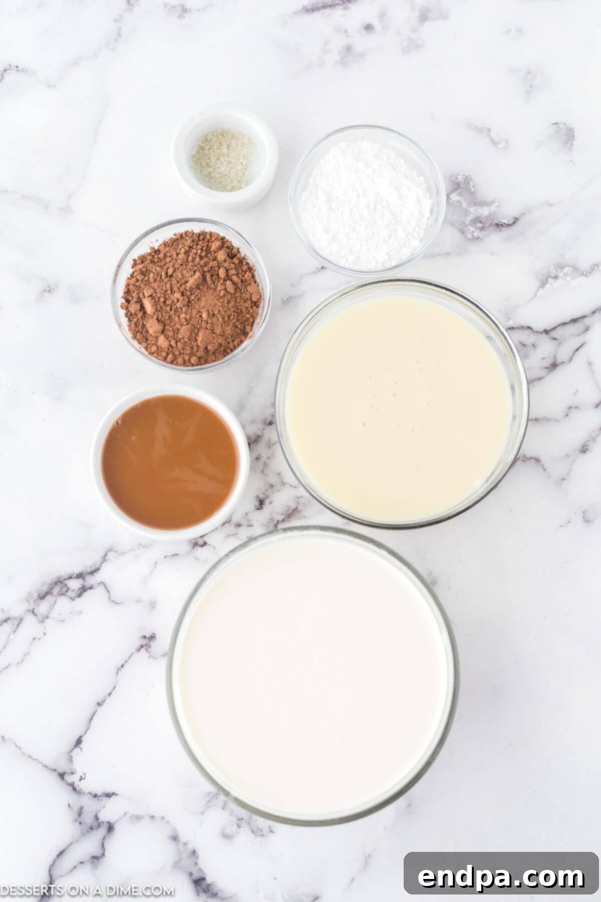 Golden Swirl Chocolate Delight 3 A flat lay photograph showcasing the key ingredients: heavy whipping cream, powdered sugar, sweetened condensed milk, cocoa powder, caramel sauce, and a small pinch of salt, all ready for mixing.