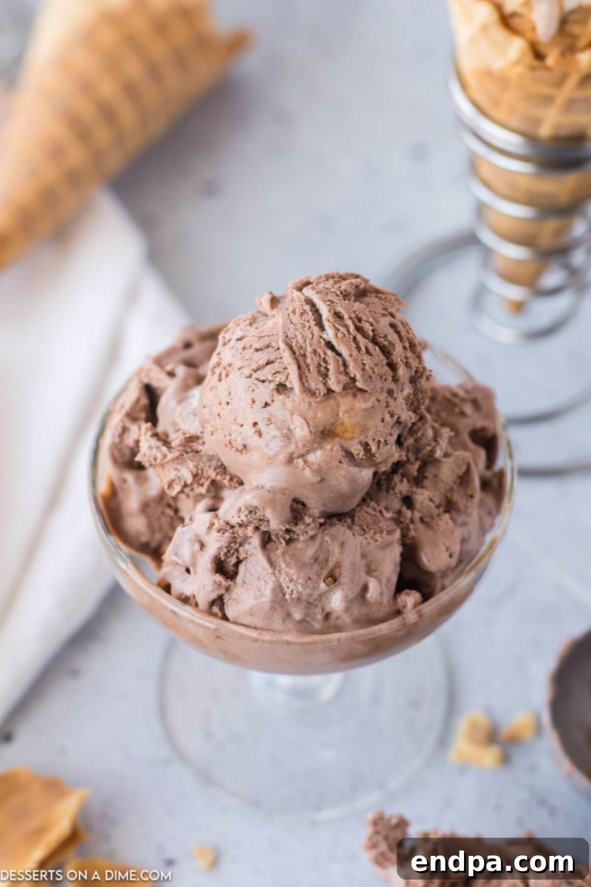 Golden Swirl Chocolate Delight 8 Several scoops of decadent chocolate caramel ice cream served in a glass bowl, garnished with a generous drizzle of caramel sauce.