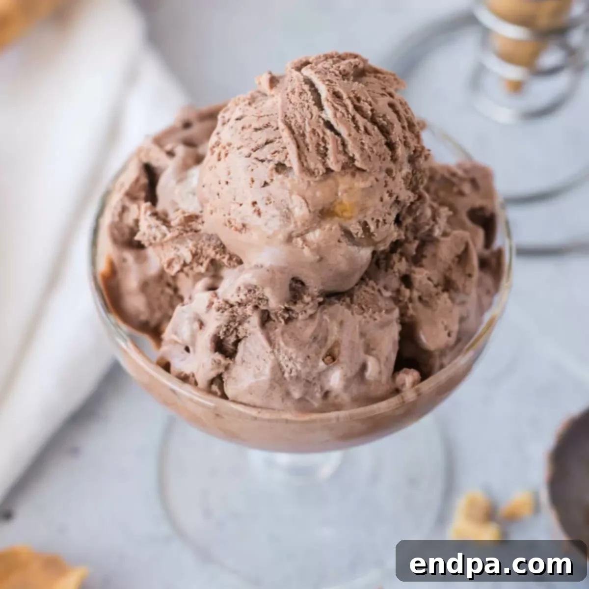 Golden Swirl Chocolate Delight 9 A close-up image of a full bowl of creamy chocolate caramel ice cream, beautifully swirled and ready to be served.