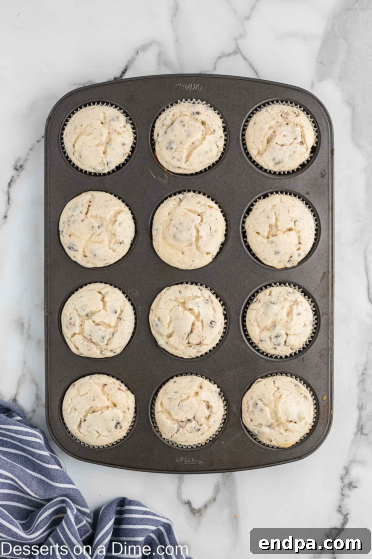 Cookies and Cream Cupcake Heaven 11 Freshly baked cupcakes cooling in the pan on a wire rack.