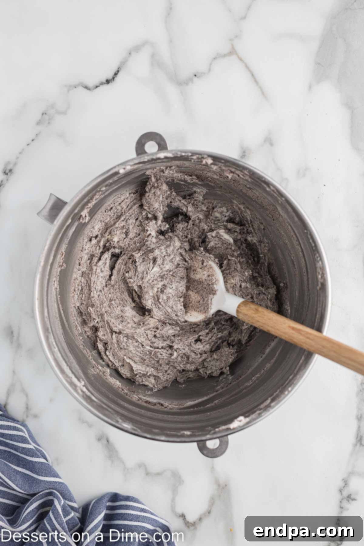 Cookies and Cream Cupcake Heaven 14 Finely crushed Oreo cookies being folded into the prepared buttercream frosting.