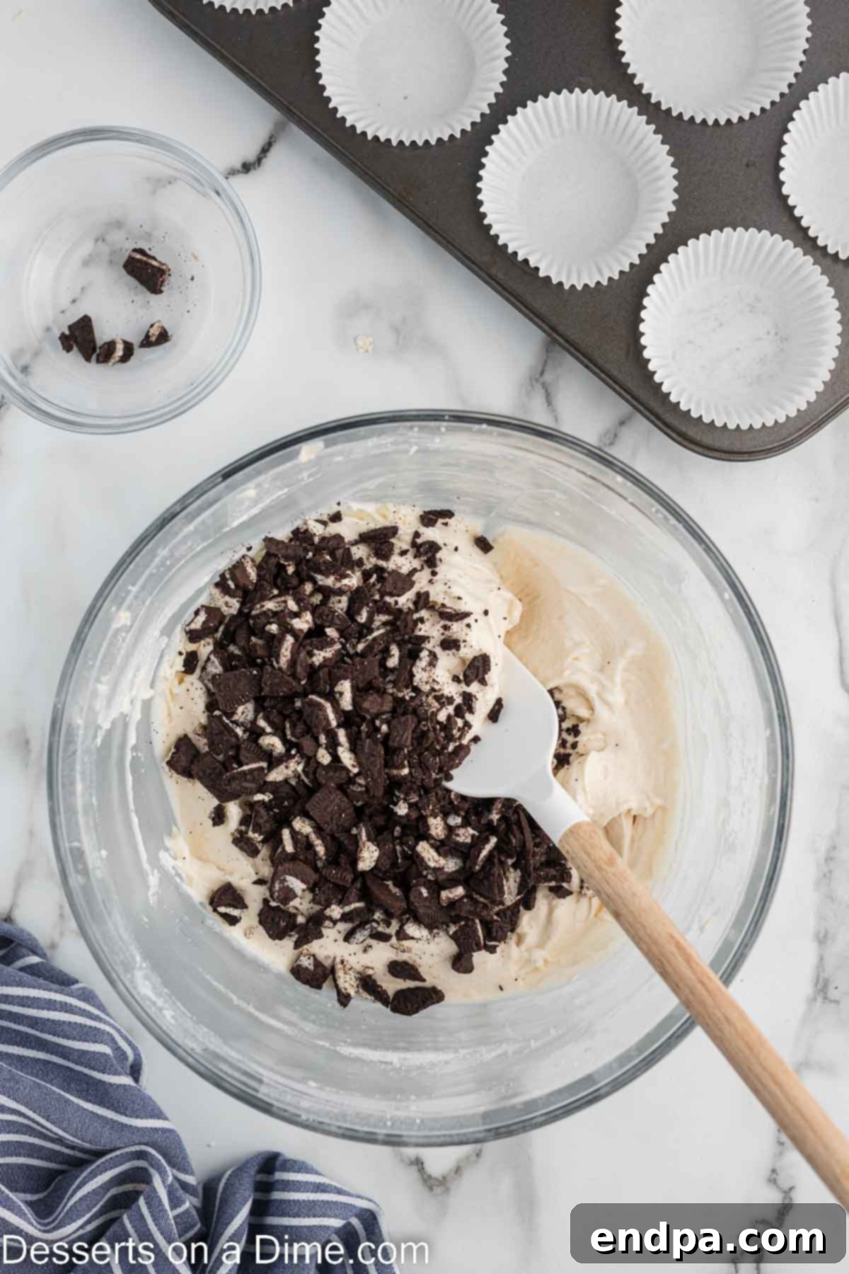 Cookies and Cream Cupcake Heaven 9 Chopped Oreo cookies being folded into the cupcake batter.