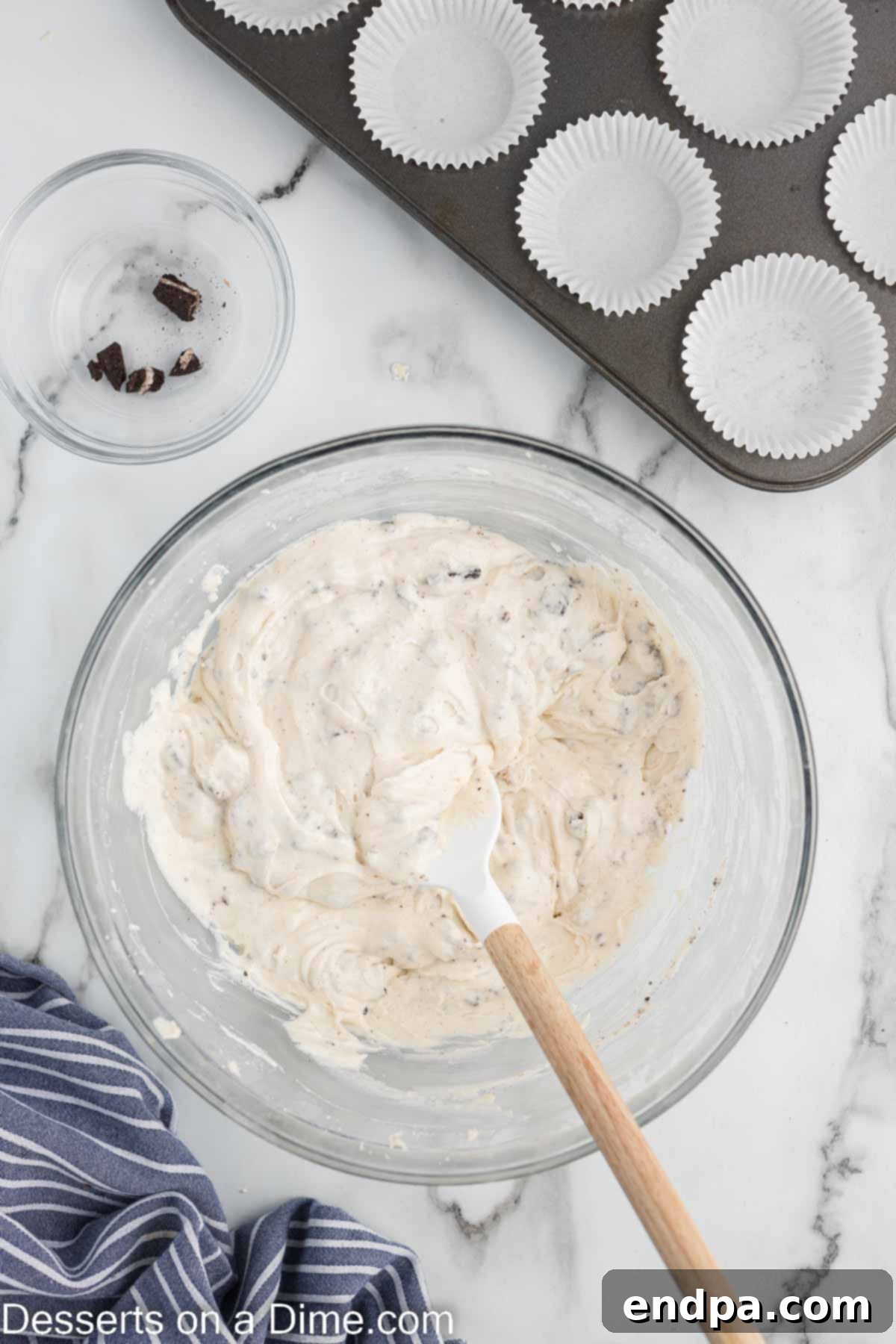 Cookies and Cream Cupcake Heaven 10 Cupcake liners filled with batter in a baking pan.