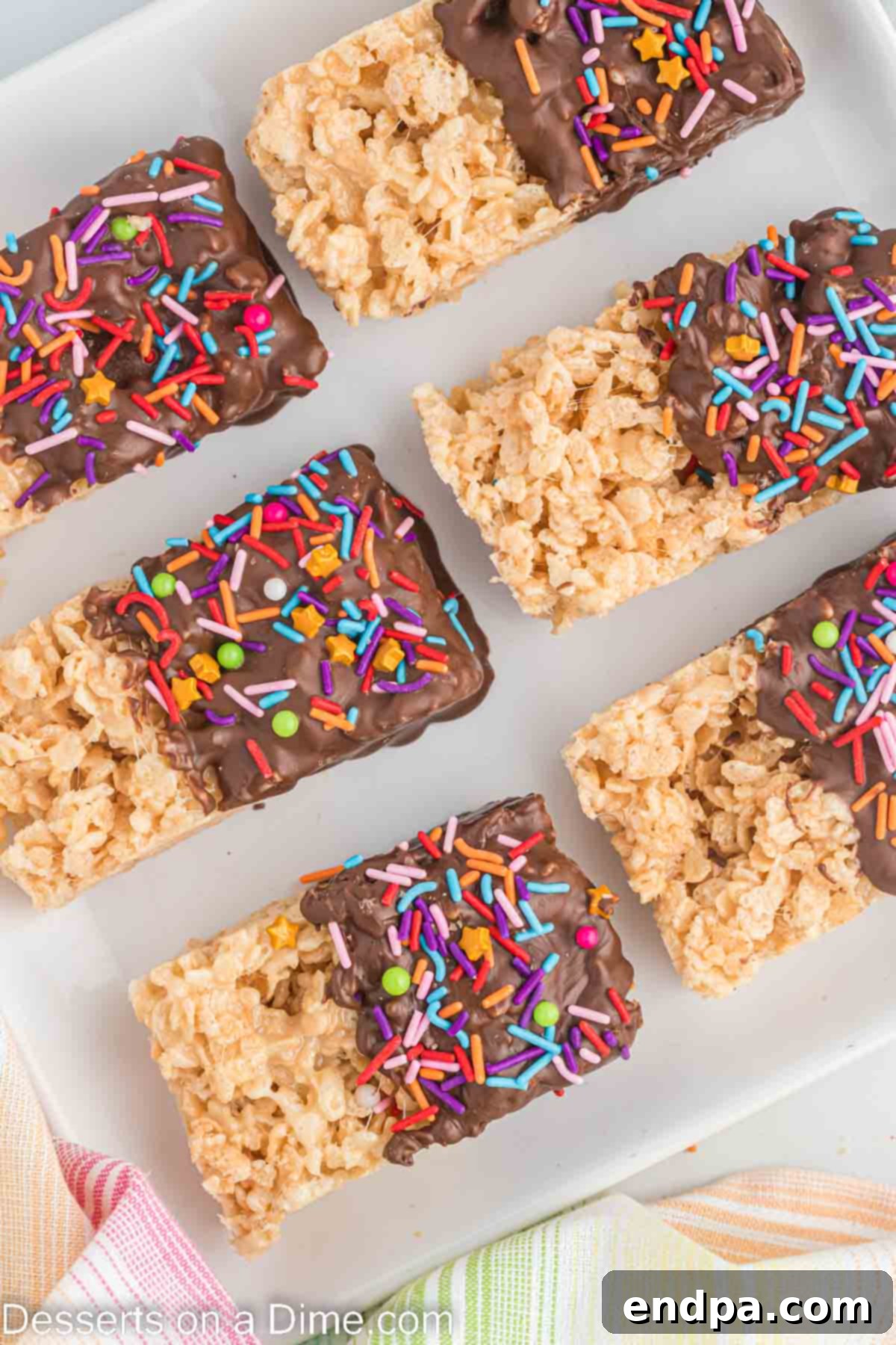 Chocolate dipped rice krispie treats ready to serve on a plate.