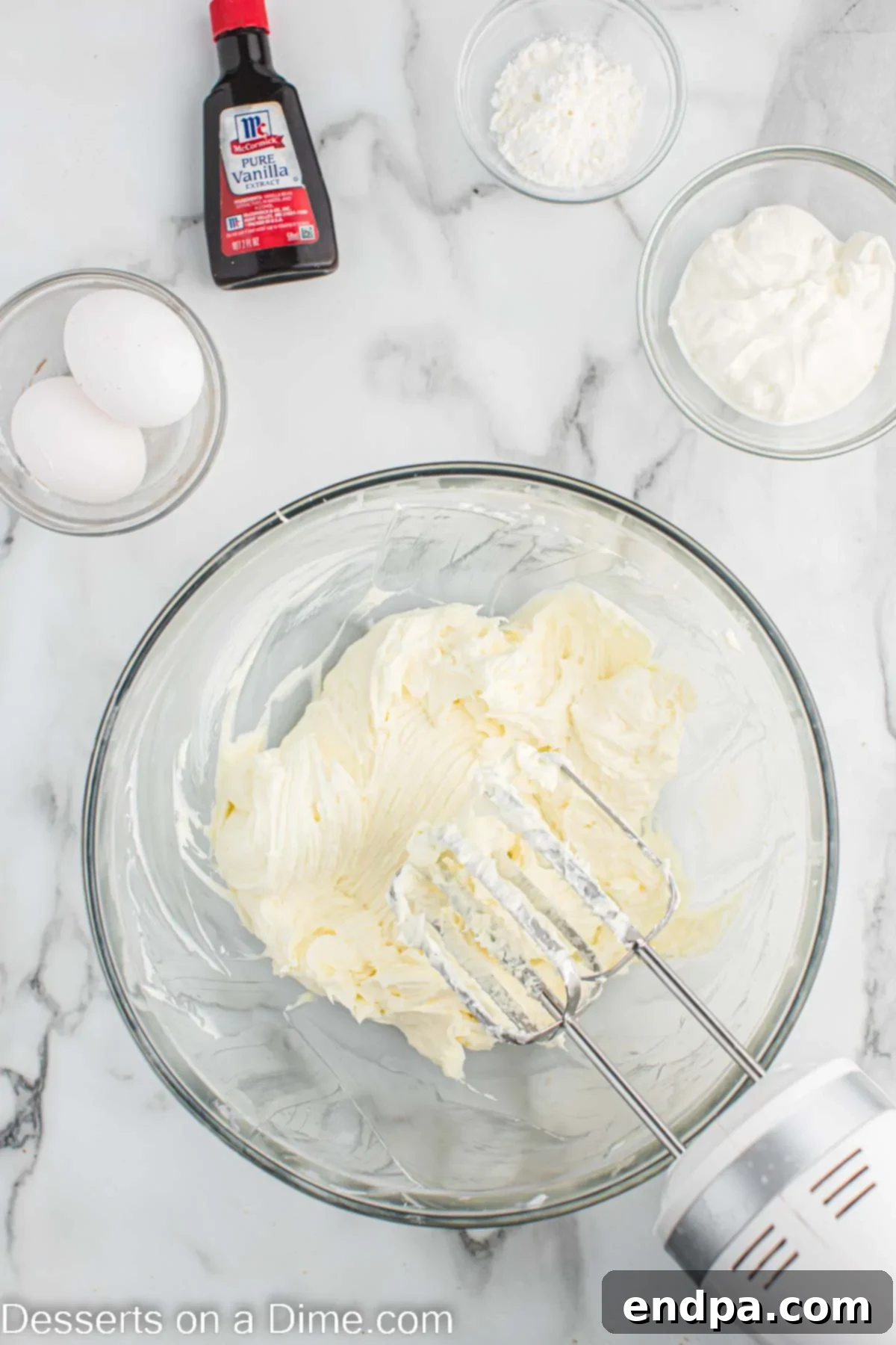 Mixing bowl with cream cheese and sugar.