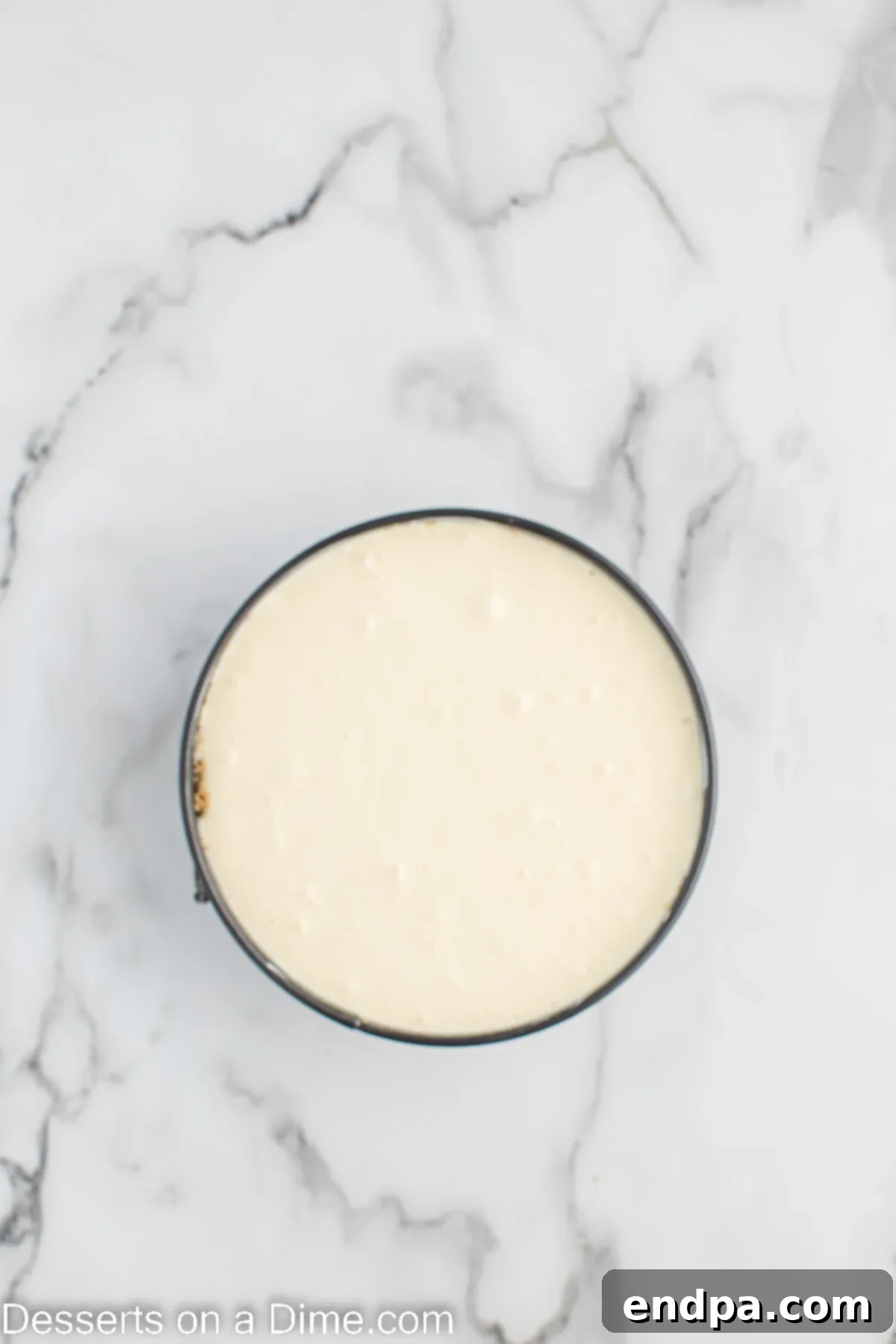 Cheesecake mixture poured into pan.