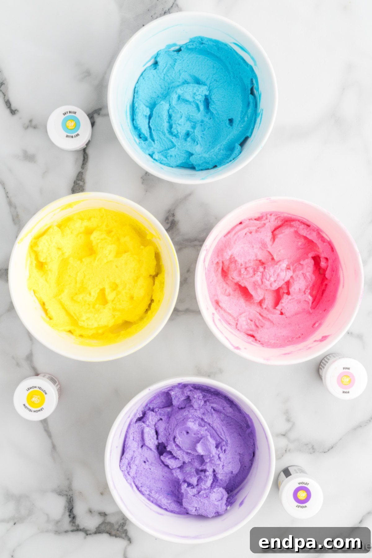 Rainbow Unicorn Dream 6 Small mixing bowls with different colors of ice cream mixture after food coloring has been added.