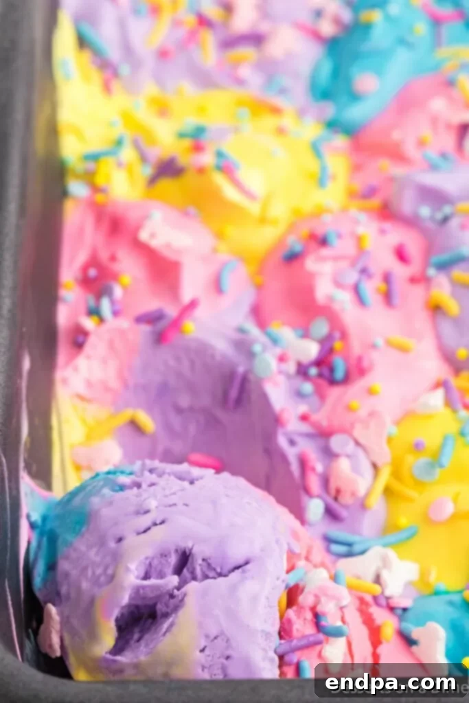 Rainbow Unicorn Dream 9 Scooped ice cream in a loaf pan, showing the colorful layers.