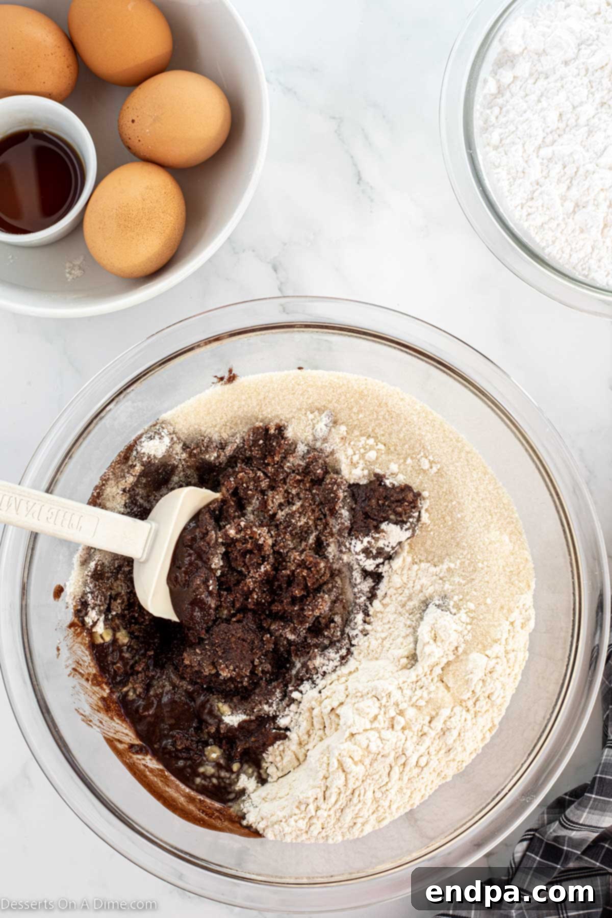 Mixing bowl with melted butter and cocoa powder combined. 