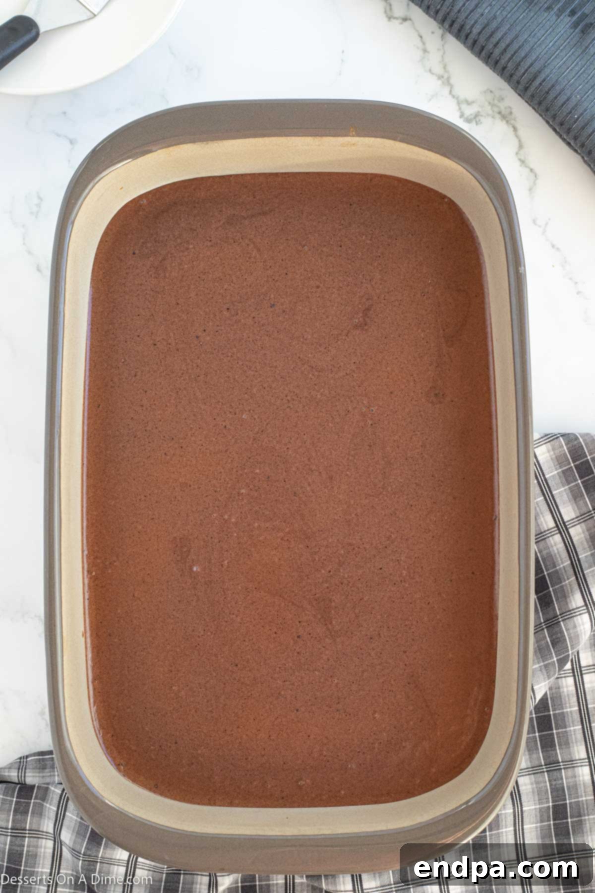 Brownies topped with frosting cooling. 