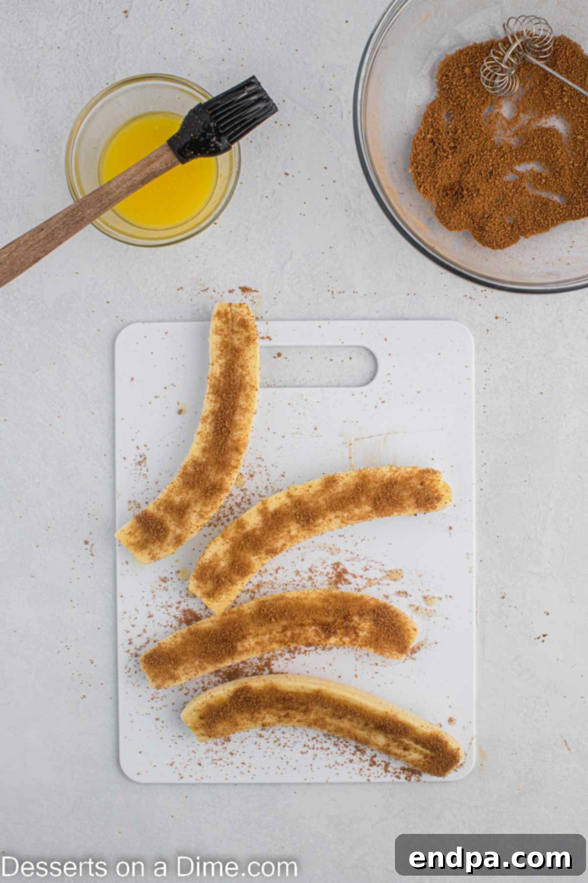 Cinnamon and brown sugar mixture sprinkled over banana slices coated in melted butter.