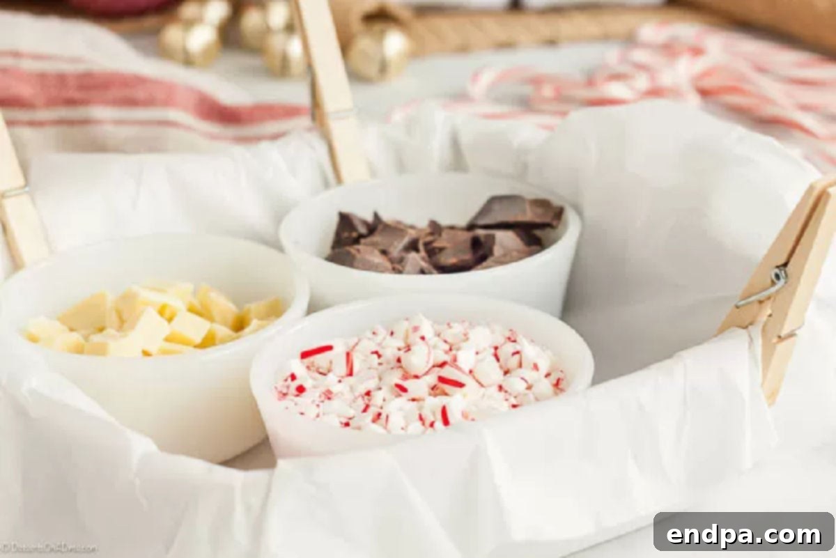 Essential ingredients for a delicious peppermint bark recipe. Ingredients needed for homemade peppermint bark: chopped dark chocolate, white chocolate, peppermint extract, and crushed candy canes.
