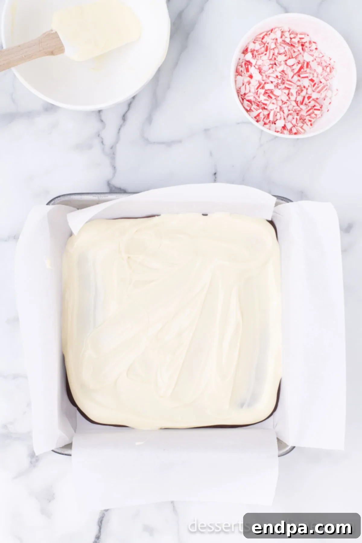 Easy Holiday Peppermint Bark 6 Melted white chocolate mixed with peppermint extract and a portion of crushed candy canes.