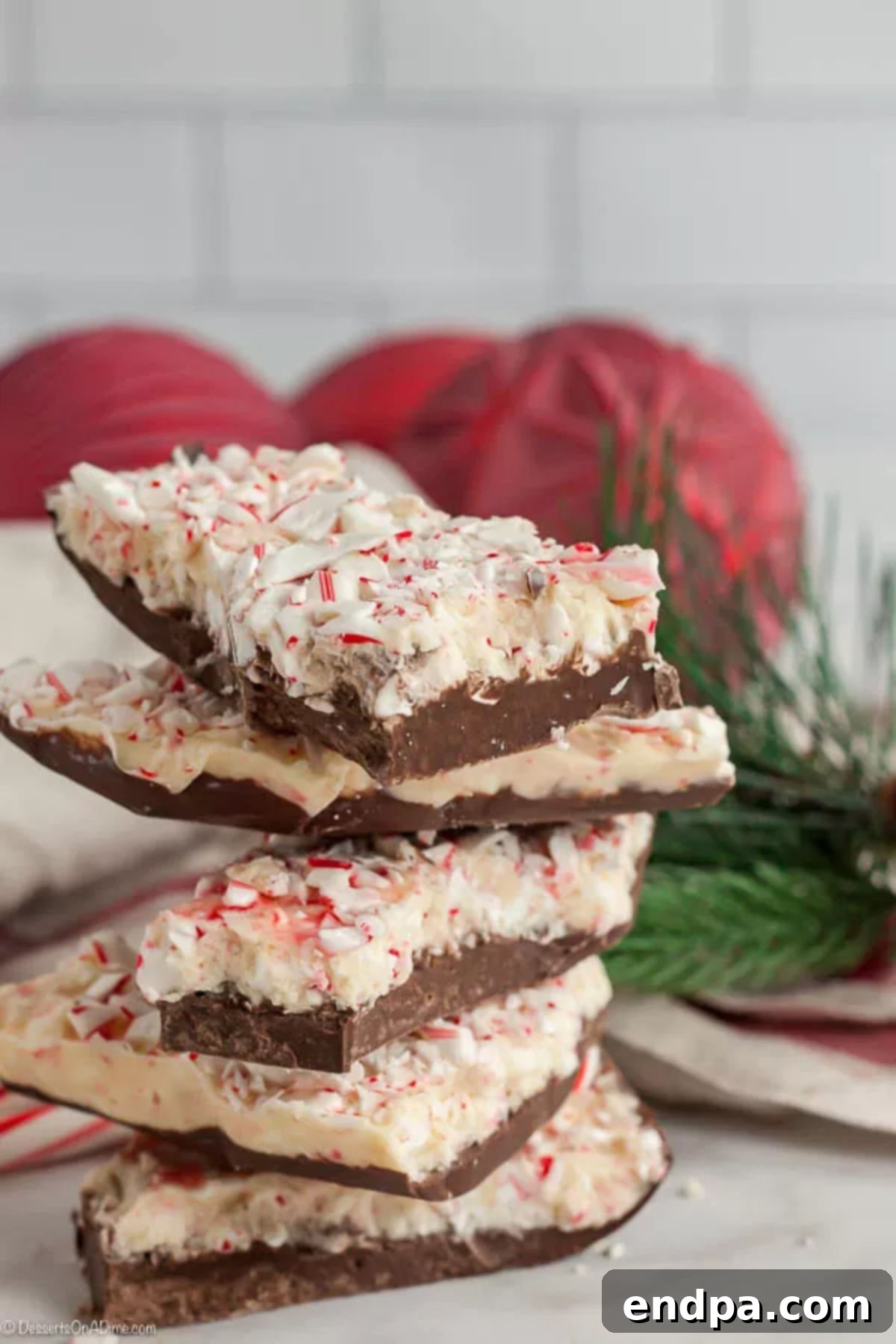 Perfectly crafted peppermint bark for holiday celebrations. Beautifully stacked pieces of delicious homemade peppermint bark, ready to be enjoyed or gifted.