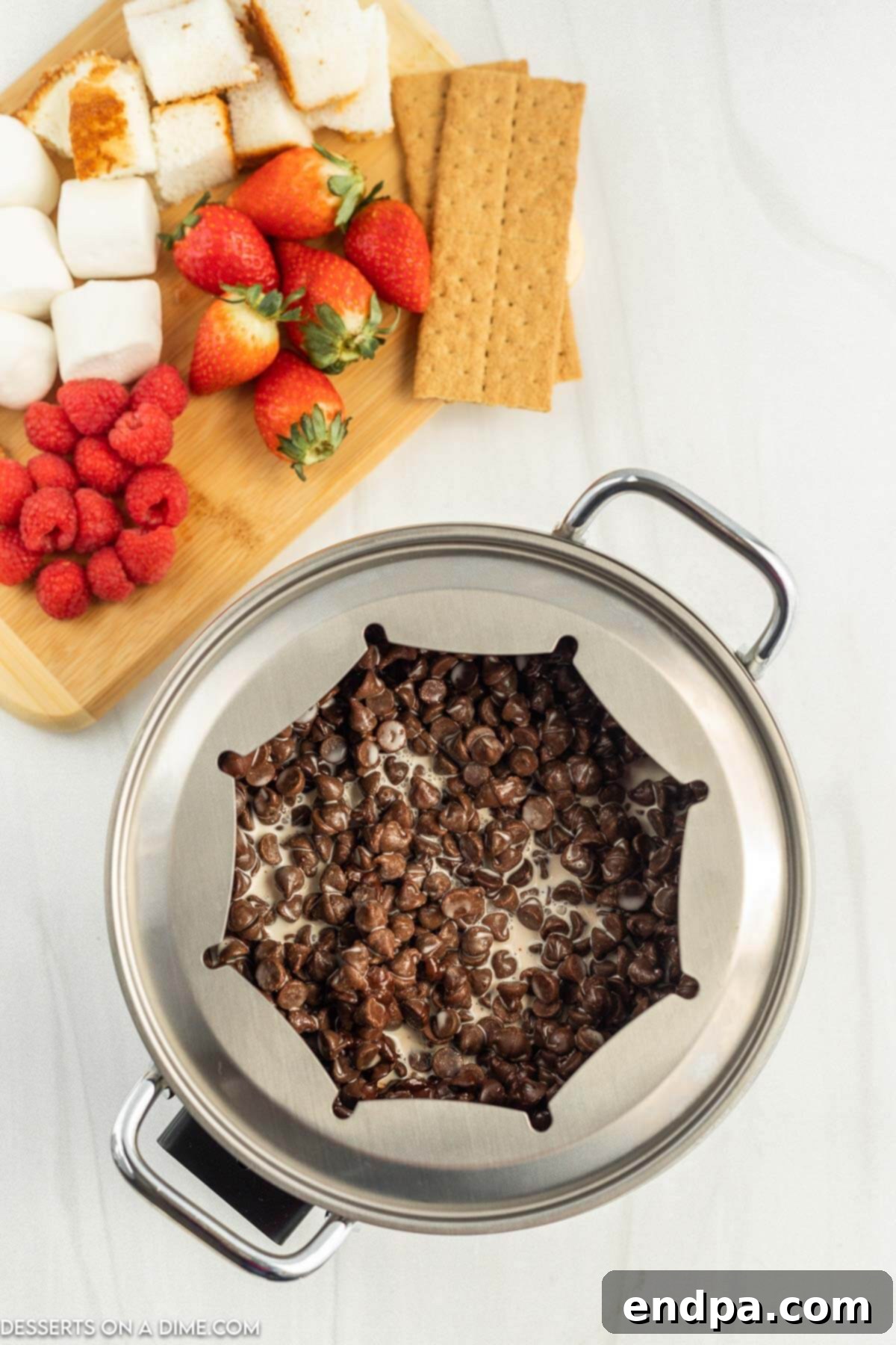 Chocolate, heavy cream, and salt being added to a fondue pot, ready to melt.