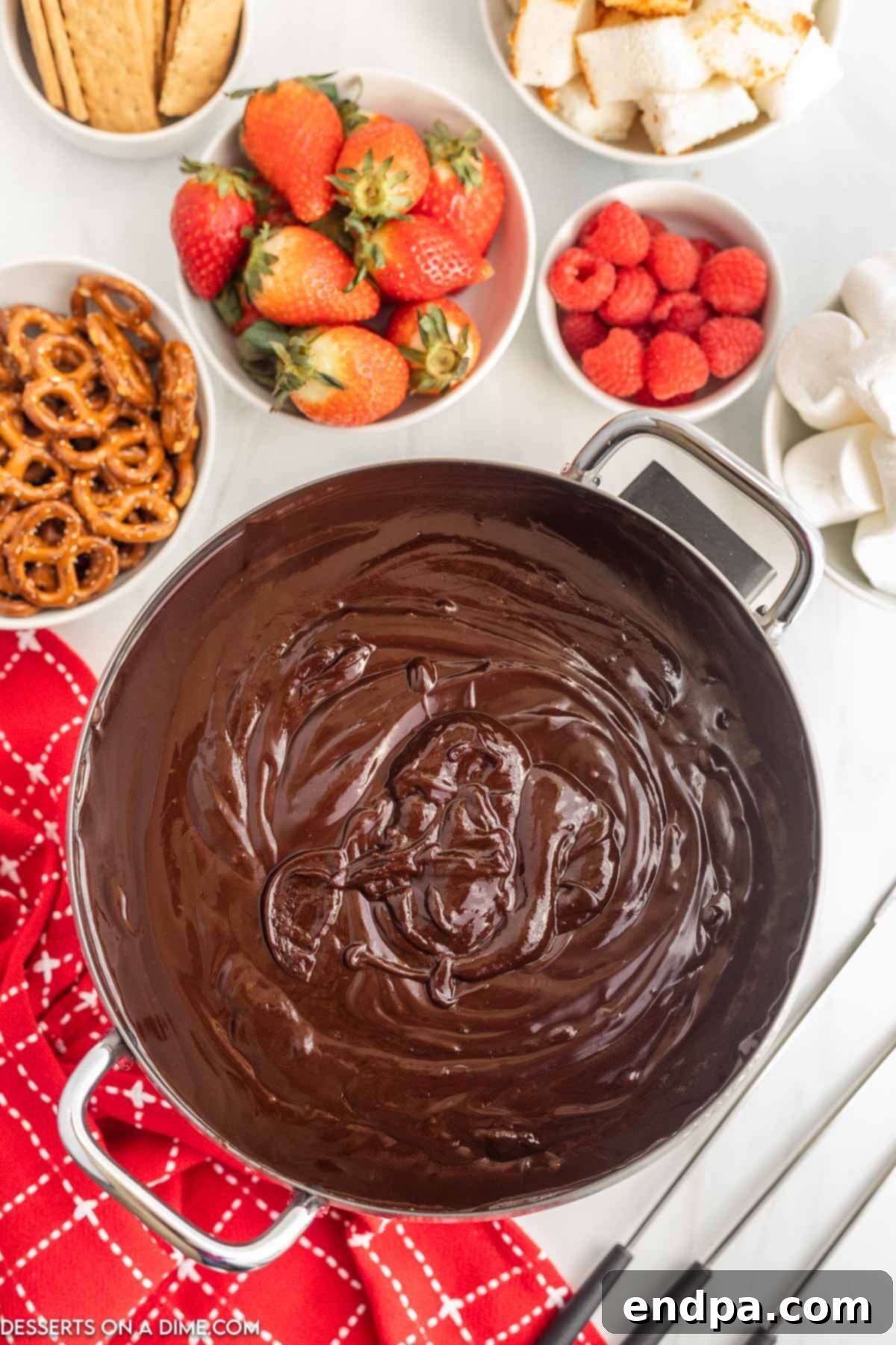 Melted, glossy chocolate in a fondue pot, stirred to perfection.