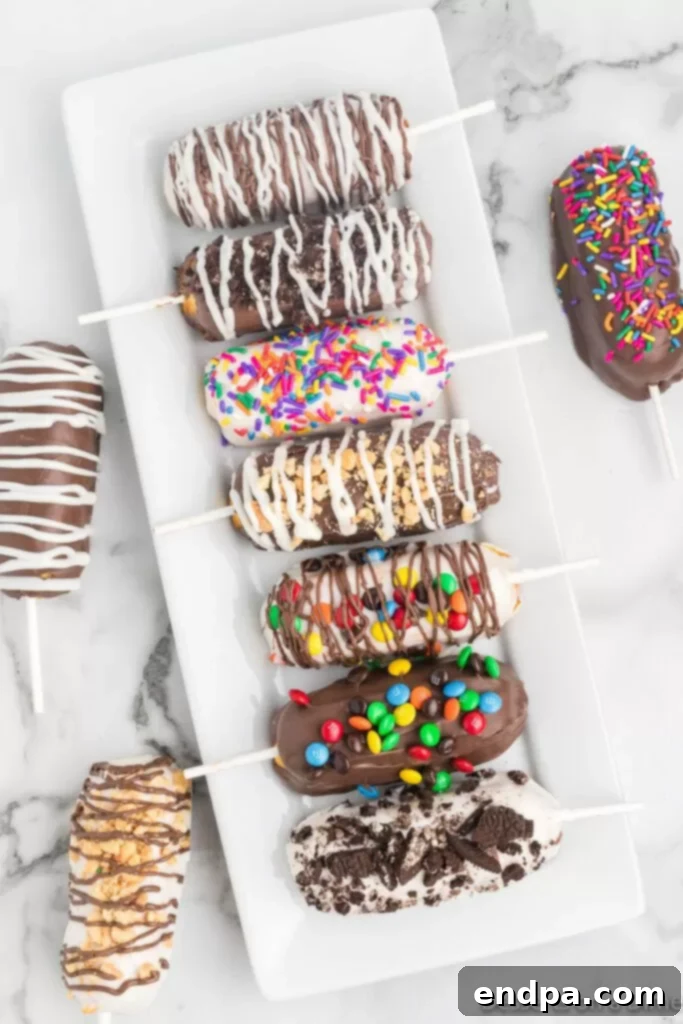 Decadent Chocolate Dipped Twinkies 8 A vibrant display of chocolate covered Twinkies, adorned with a variety of colorful sprinkles and drizzles, presented on a white platter.