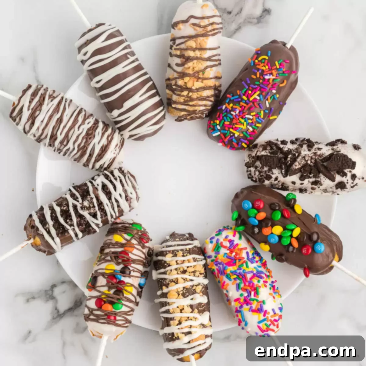 Decadent Chocolate Dipped Twinkies 9 Chocolate covered Twinkies arranged on a white plate, showcasing various toppings.