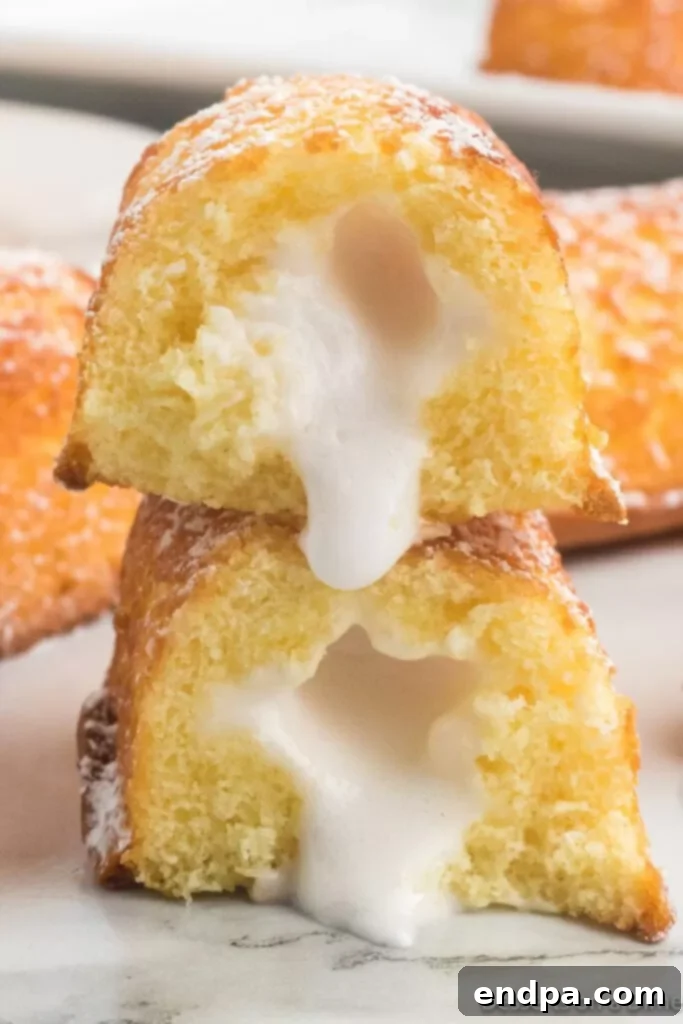 A freshly air-fried Twinkie, cut in half to reveal its perfectly warm and gooey cream filling.