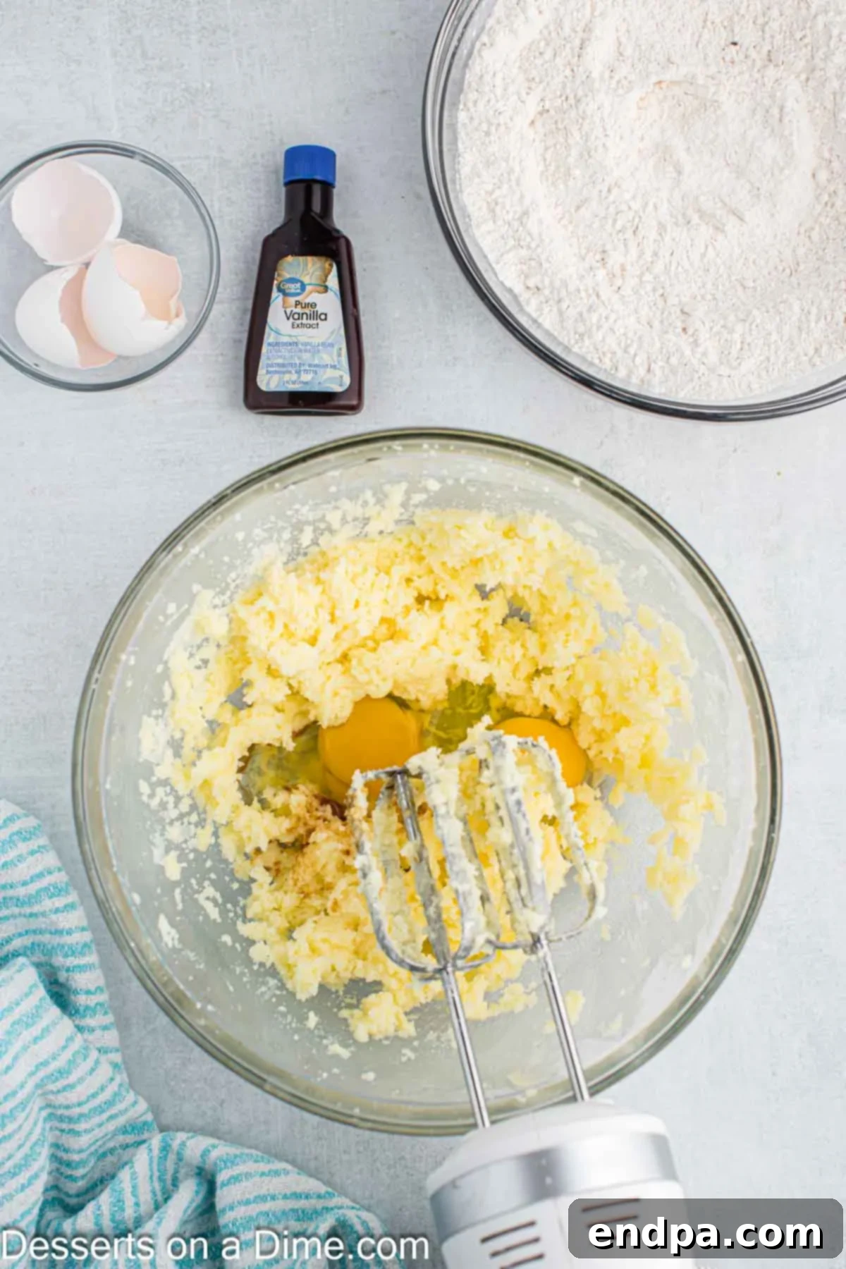 Enchanted Unicorn Treats 6 Room temperature eggs being added to the creamed butter and sugar mixture in a bowl.