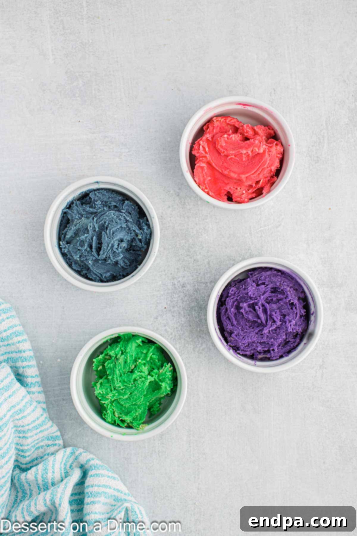 Enchanted Unicorn Treats 9 Cookie dough divided into four separate bowls, each tinted with a different vibrant gel food coloring.