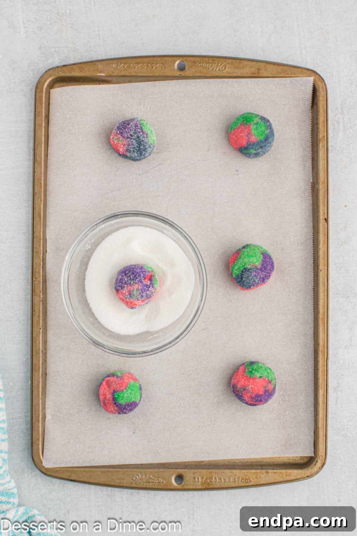 Enchanted Unicorn Treats 10 Small, multi-colored cookie dough balls rolled in granulated sugar, ready for baking.