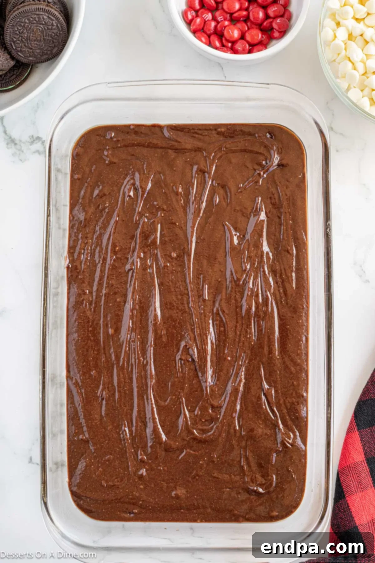 Grinch Green Brownies 5 Brownie batter poured evenly into a prepared baking pan, ready for the oven.