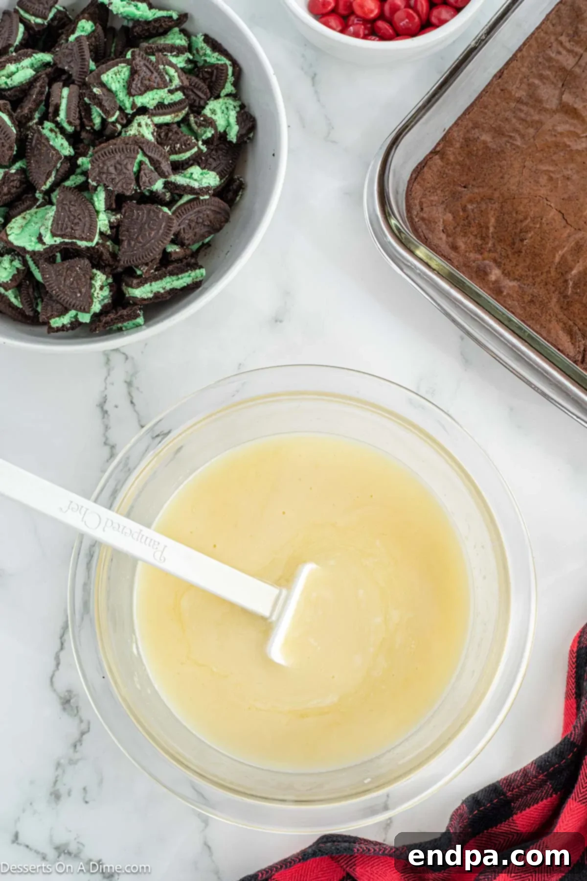 Grinch Green Brownies 7 White chocolate chips and heavy cream in a microwave-safe bowl, ready for melting.