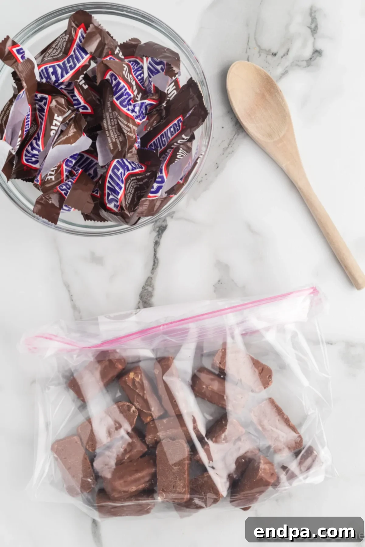 Decadent Homemade Snickers Ice Cream 4 An open bag of fun-size Snickers candy bars, ready to be crushed.