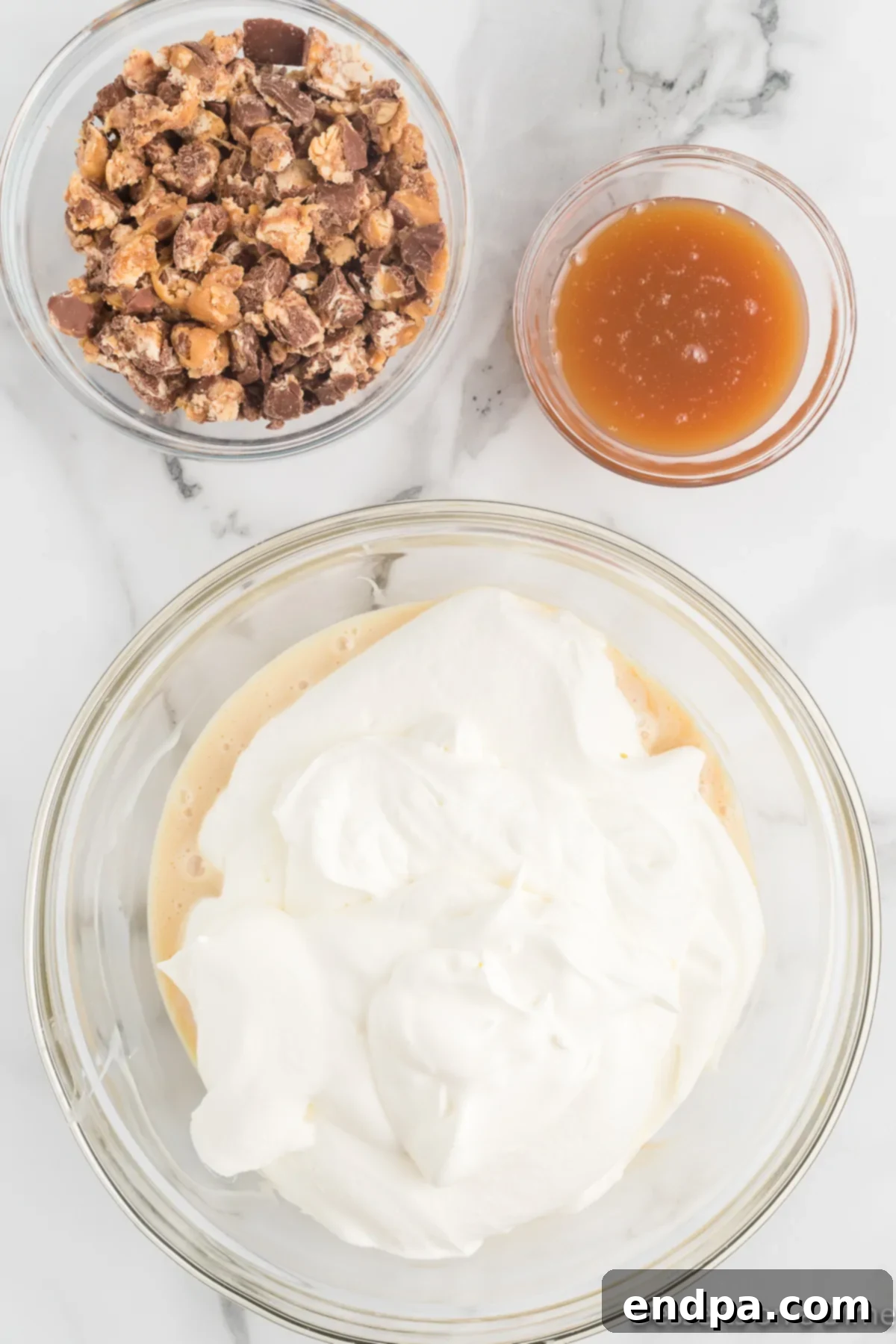 Decadent Homemade Snickers Ice Cream 7 Whipped cream gently folded into the sweetened condensed milk mixture.