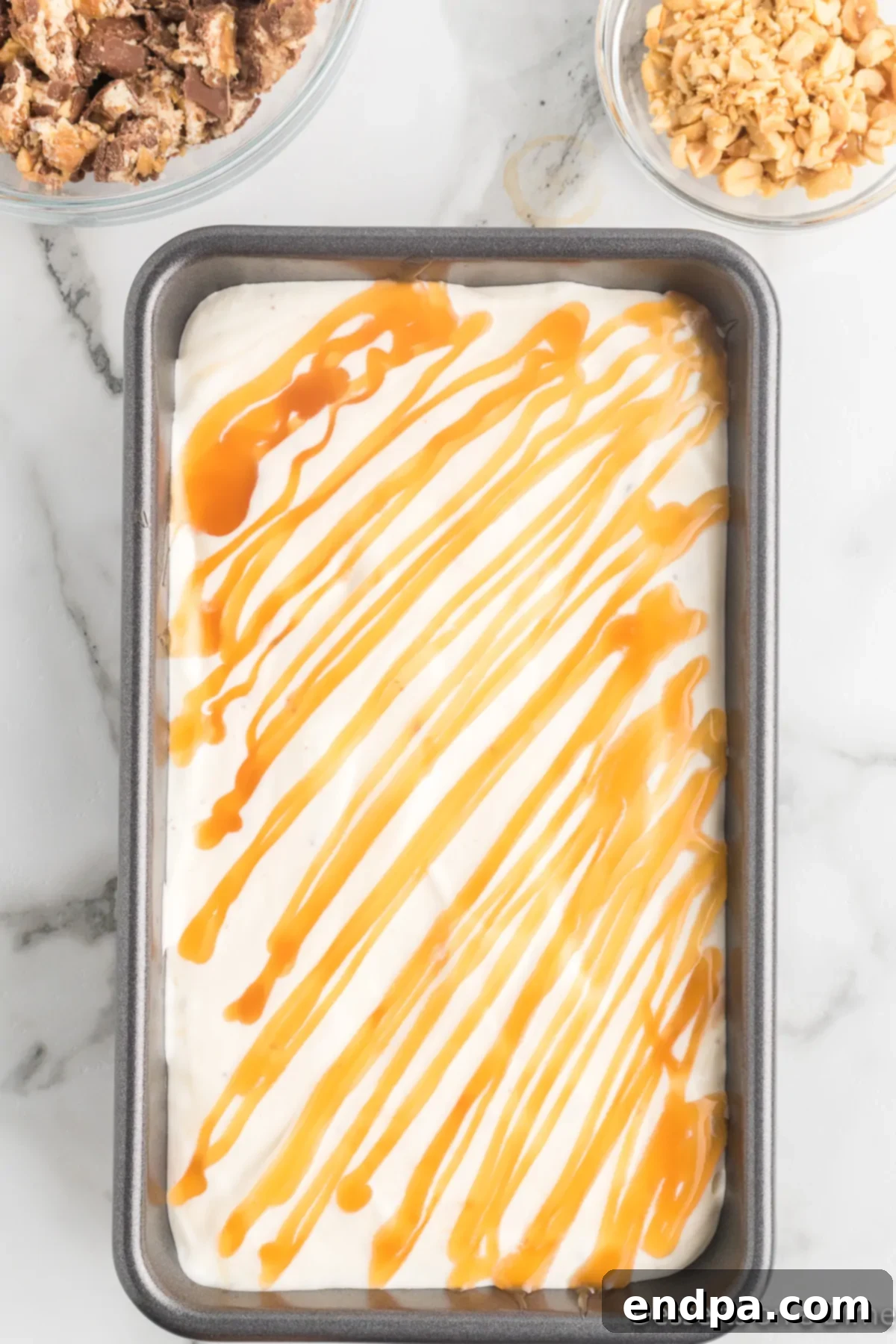 Decadent Homemade Snickers Ice Cream 9 The Snickers ice cream mixture evenly spread into a loaf pan, ready for freezing.