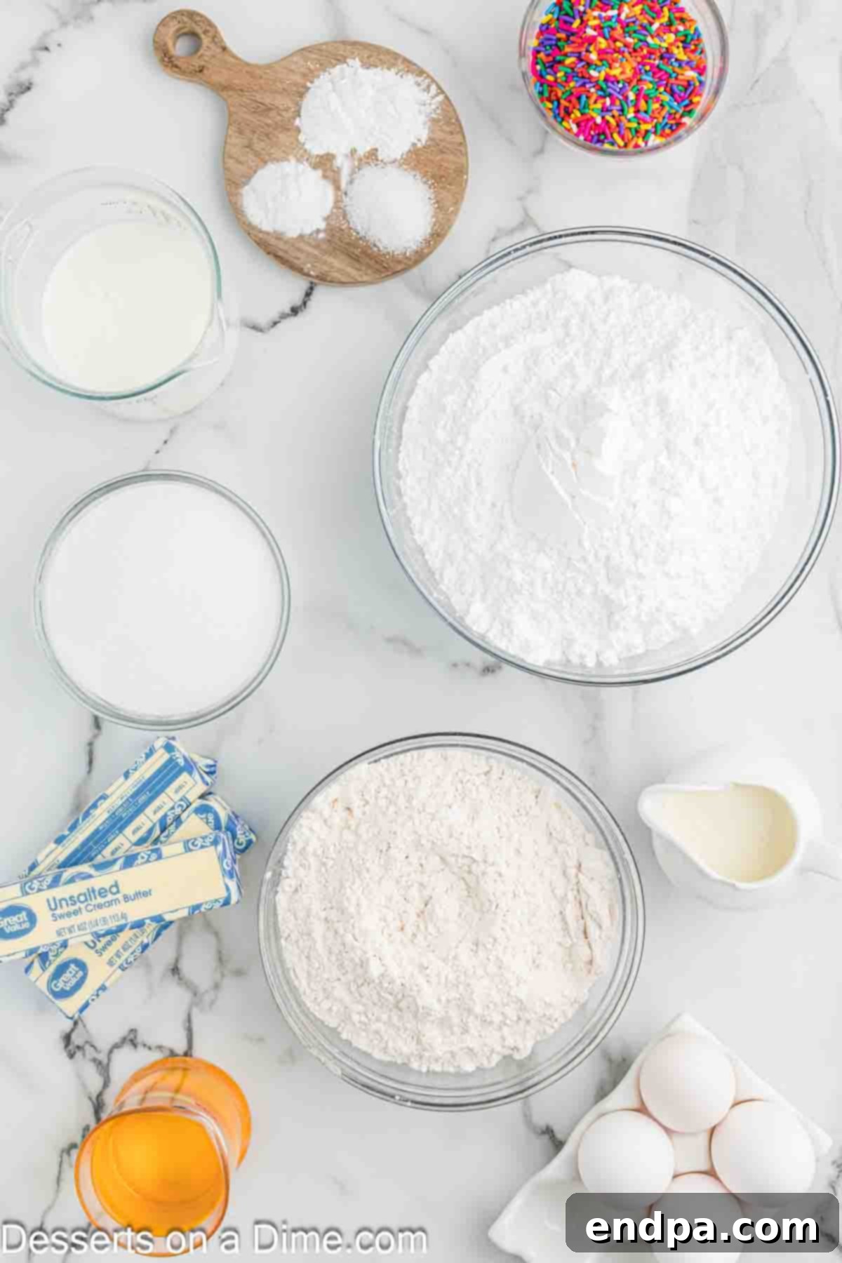 A flat lay image showing all the dry and wet ingredients neatly arranged for making confetti cupcakes.