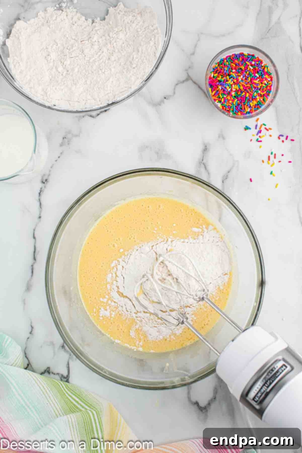 Alternating addition of dry ingredients and buttermilk into the wet mixture.