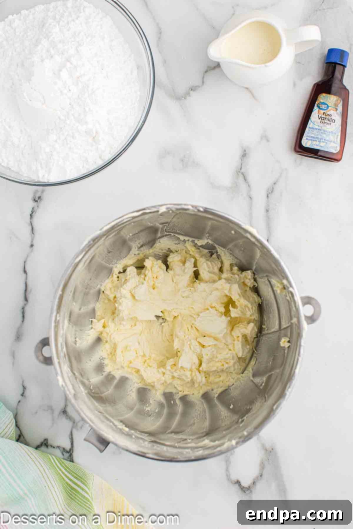 Butter being beaten until fluffy in a mixer, for frosting preparation.