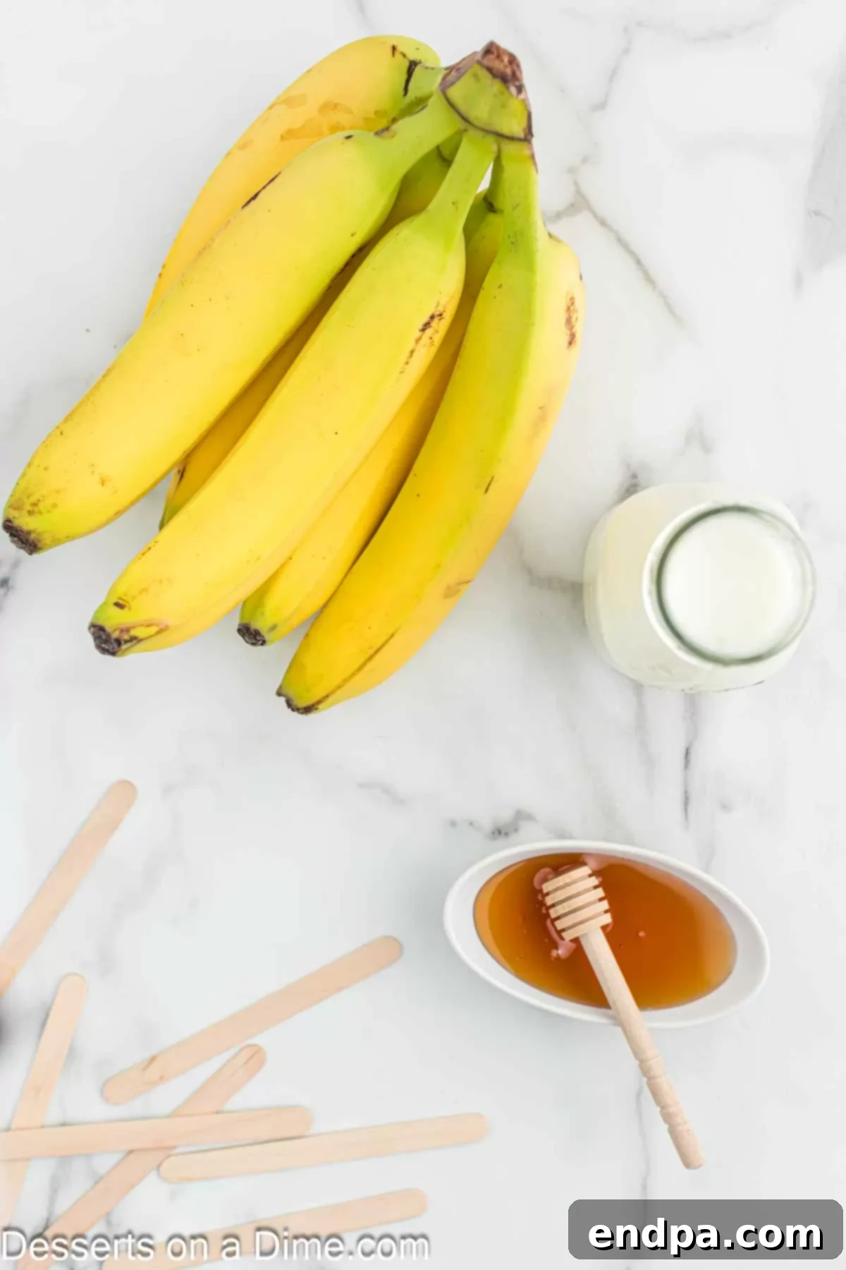 Frozen Banana Delights 3 Ingredients for Banana popsicles - milk, bananas, honey.