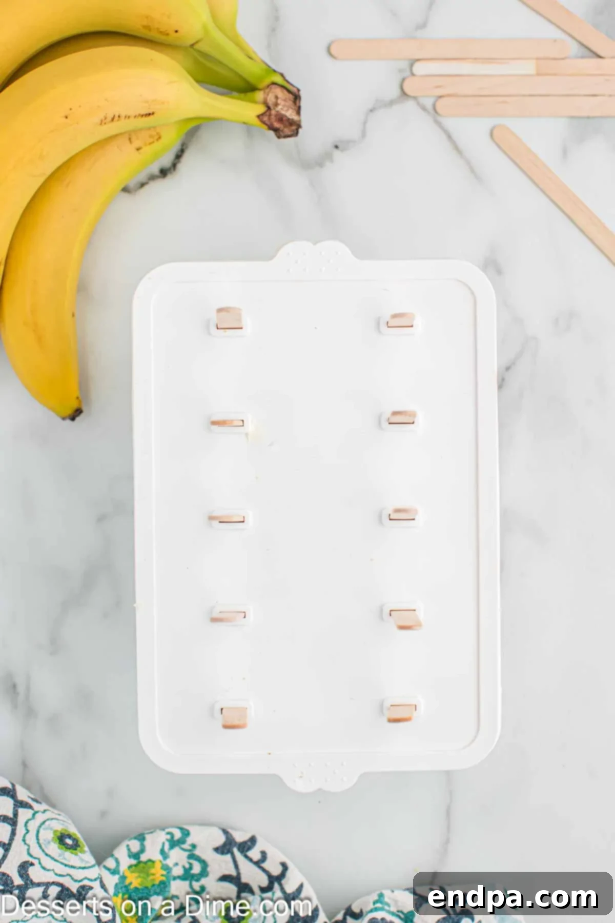 Frozen Banana Delights 6 Popsicle sticks in mold.