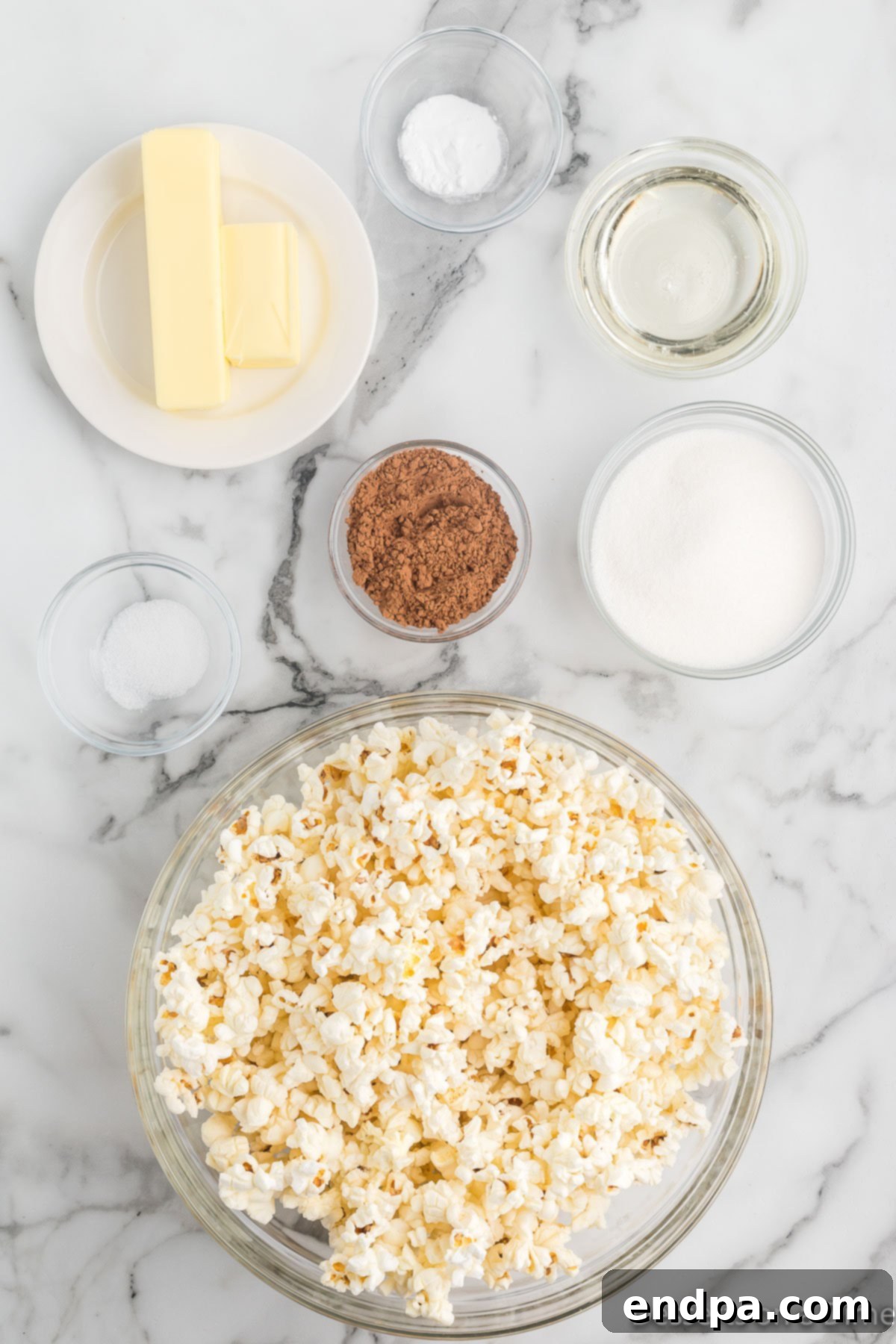 Decadent Chocolate Popcorn 3 Ingredients for chocolate popcorn - popped popcorn, butter, cocoa powder, baking soda, sugar.