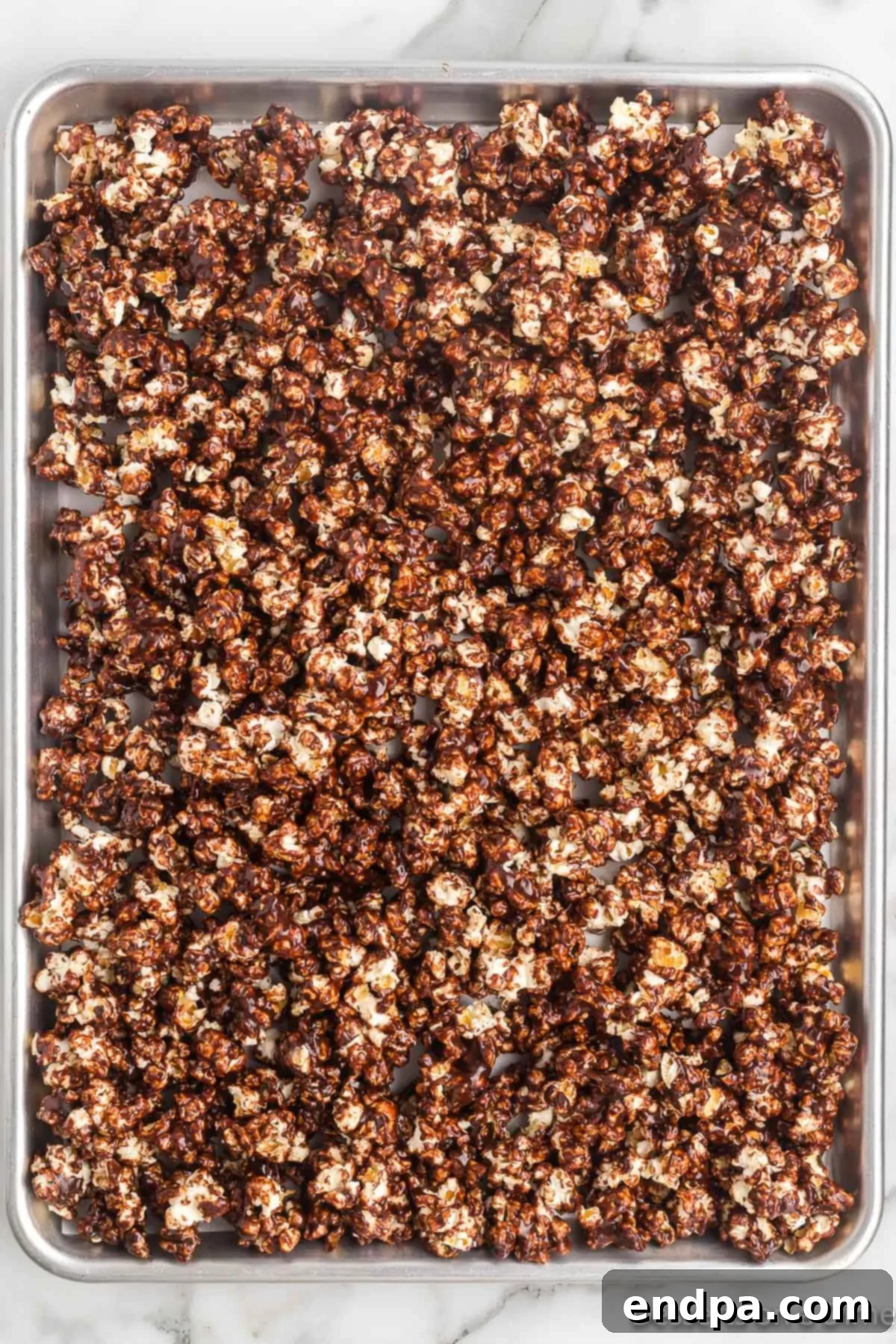 Decadent Chocolate Popcorn 5 Popcorn spread on baking sheet.