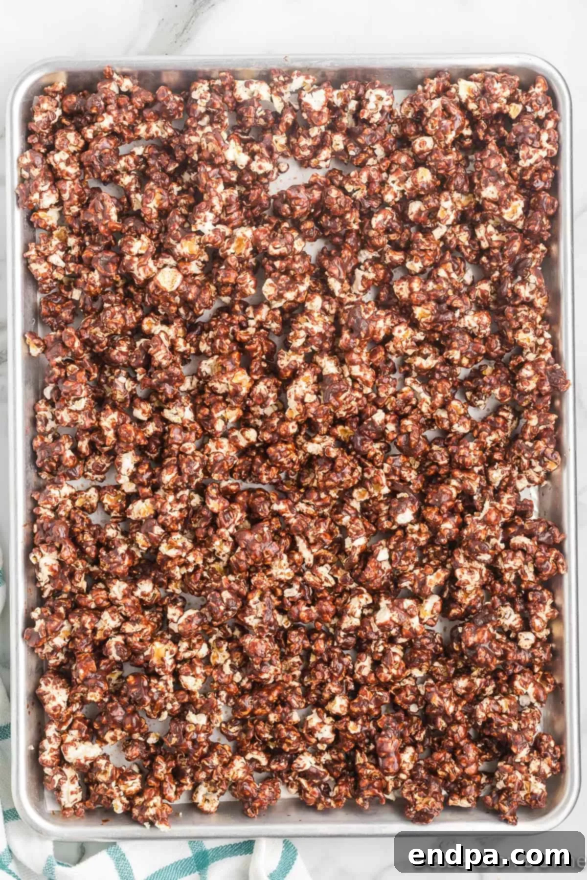 Decadent Chocolate Popcorn 6 Popcorn on baking sheet cooling.