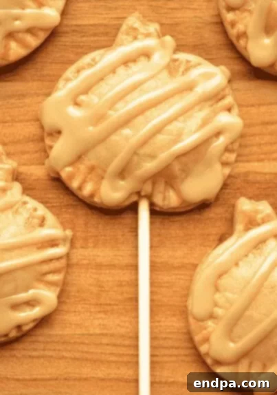 Mini pumpkin pie pops on sticks, resembling lollipops.